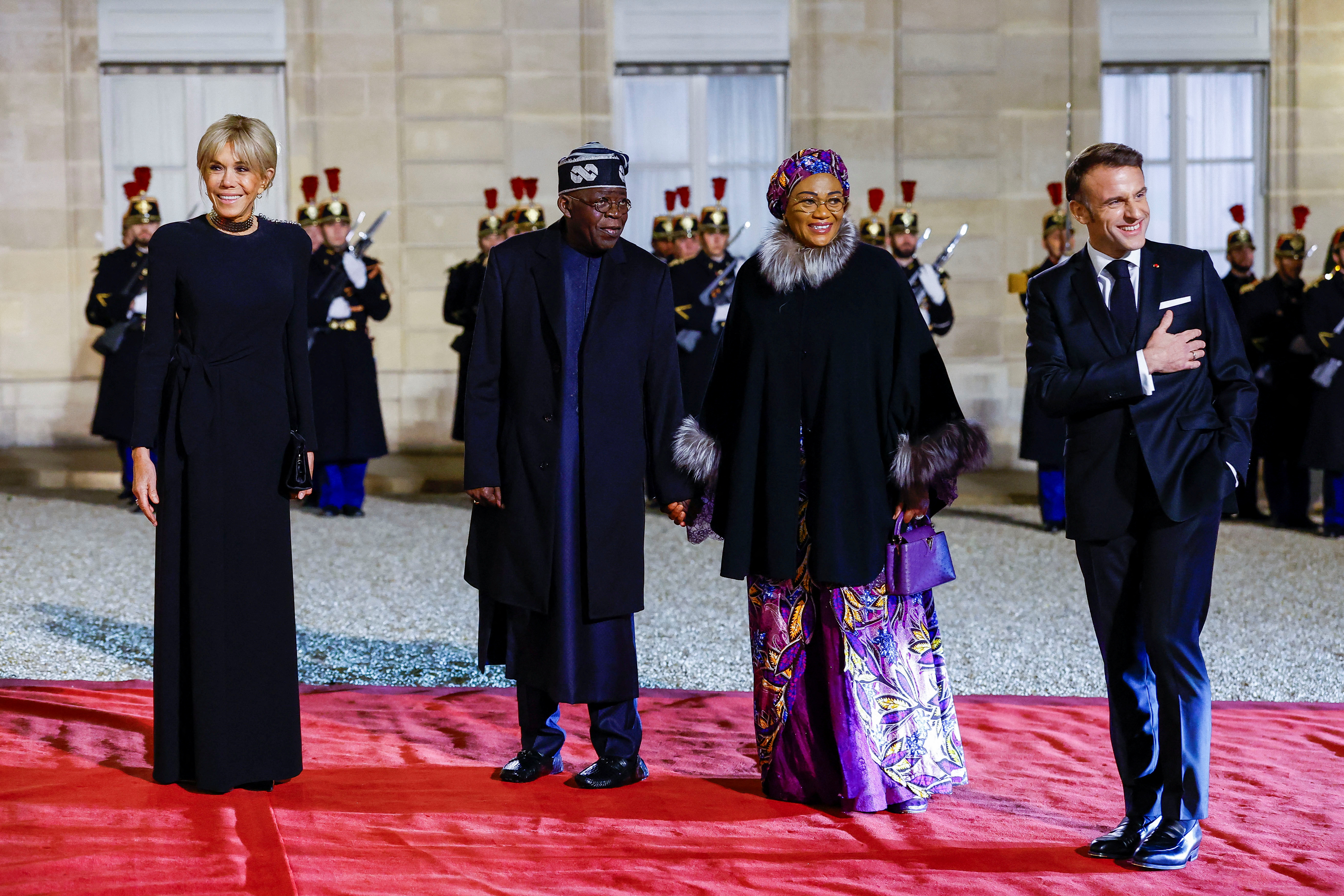 French President Emmanuel Macron and his wife Brigitte Macron welcome Nigerian President Bola Ahmed Tinubu and his wife Oluremi "Remi" Tinubu for a state dinner at the Elysee Palace in Paris as part of his two-day state visit to France, November 28, 2024. REUTERS/Stephanie Lecocq