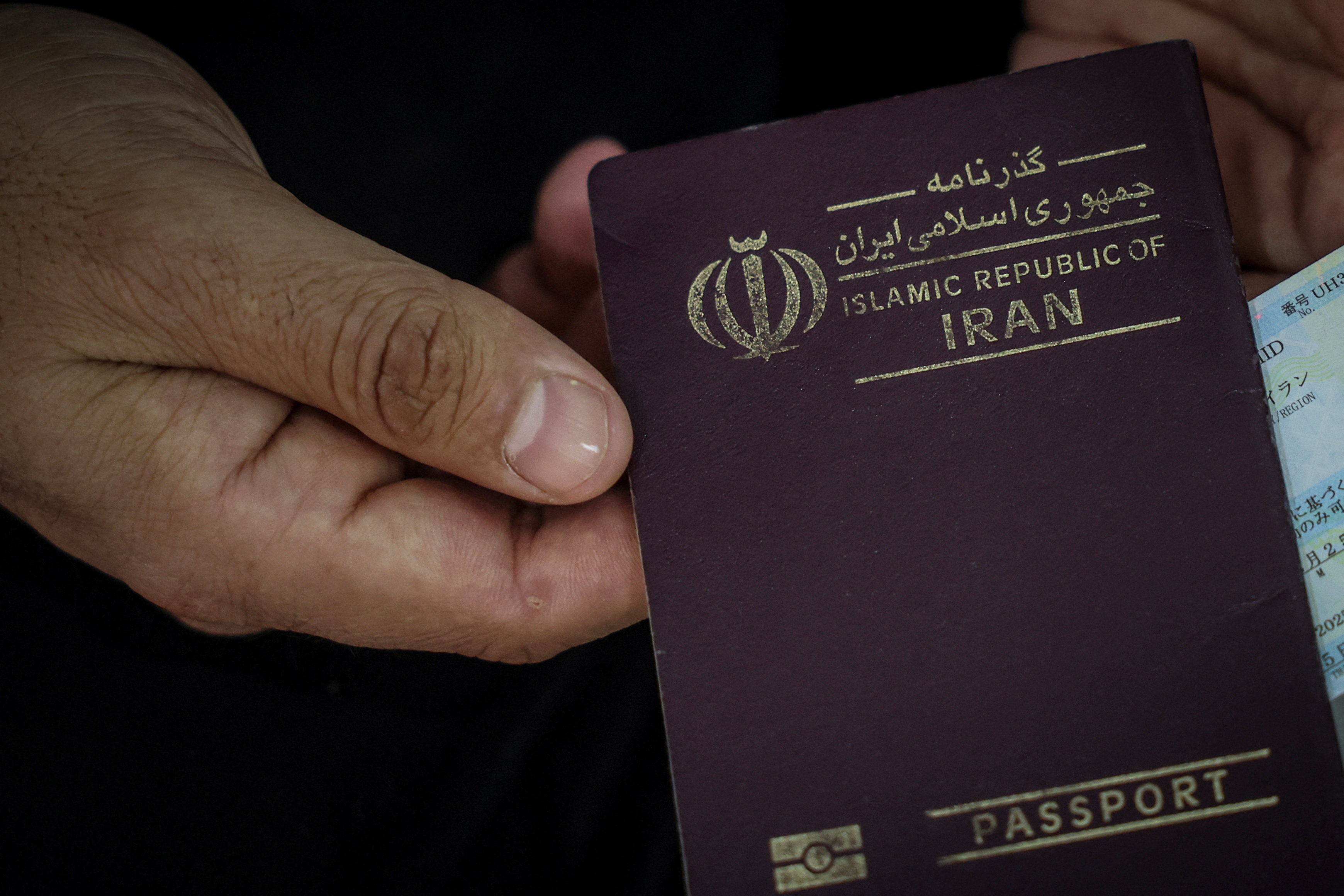 Hamid Shirmohammadzadeh, 35, who arrived in Turkey from Iran, shows his passport while staying at a hotel in Van province, Turkey, March 5, 2026. REUTERS/Dilara Senkaya SEARCH "SENKAYA IRAN CRISIS TURKEY BORDER" FOR THIS STORY. SEARCH "WIDER IMAGE" FOR ALL STORIES.