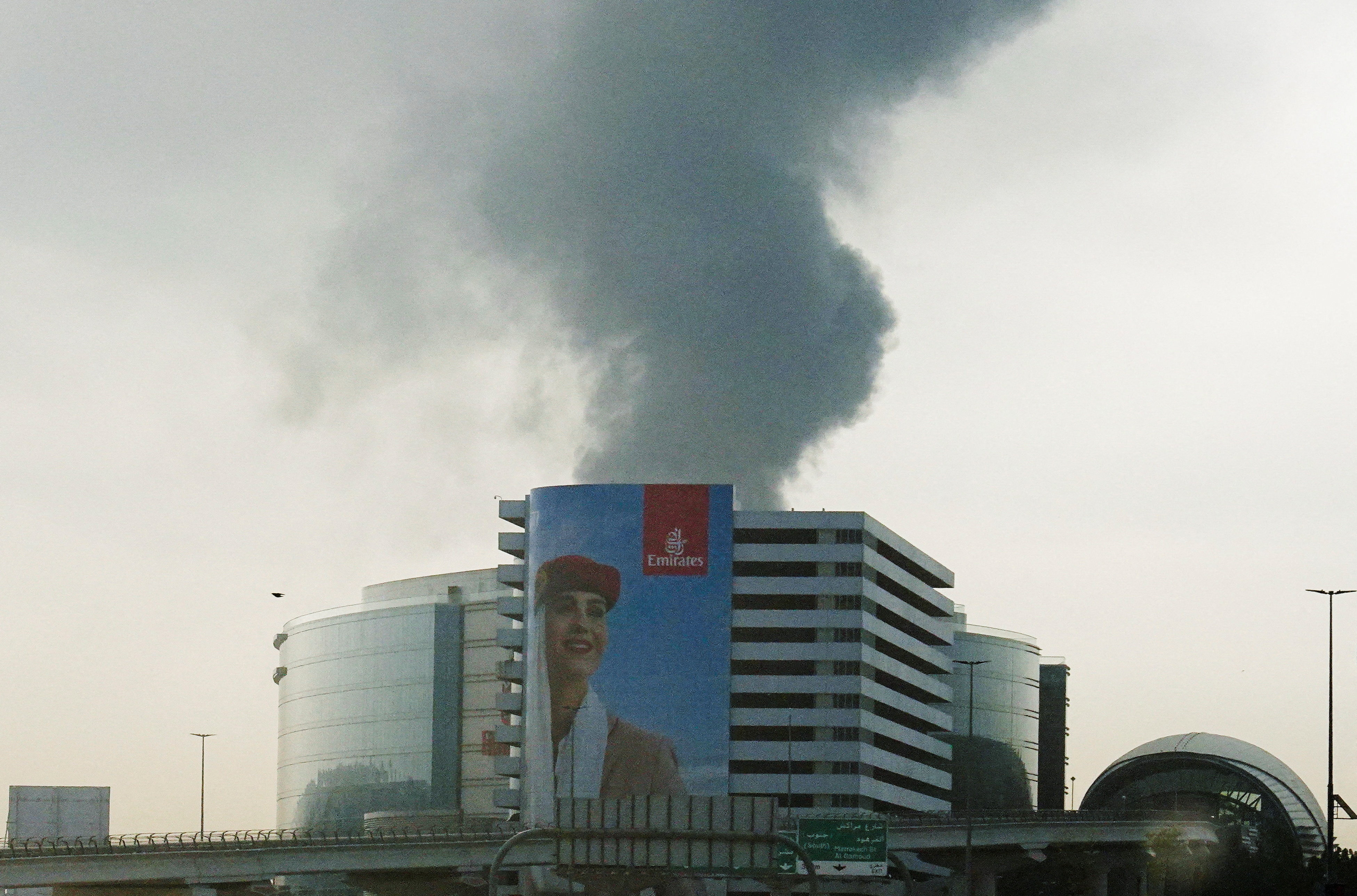 Smoke rises from Dubai international airport after a drone attack hit a fuel tank