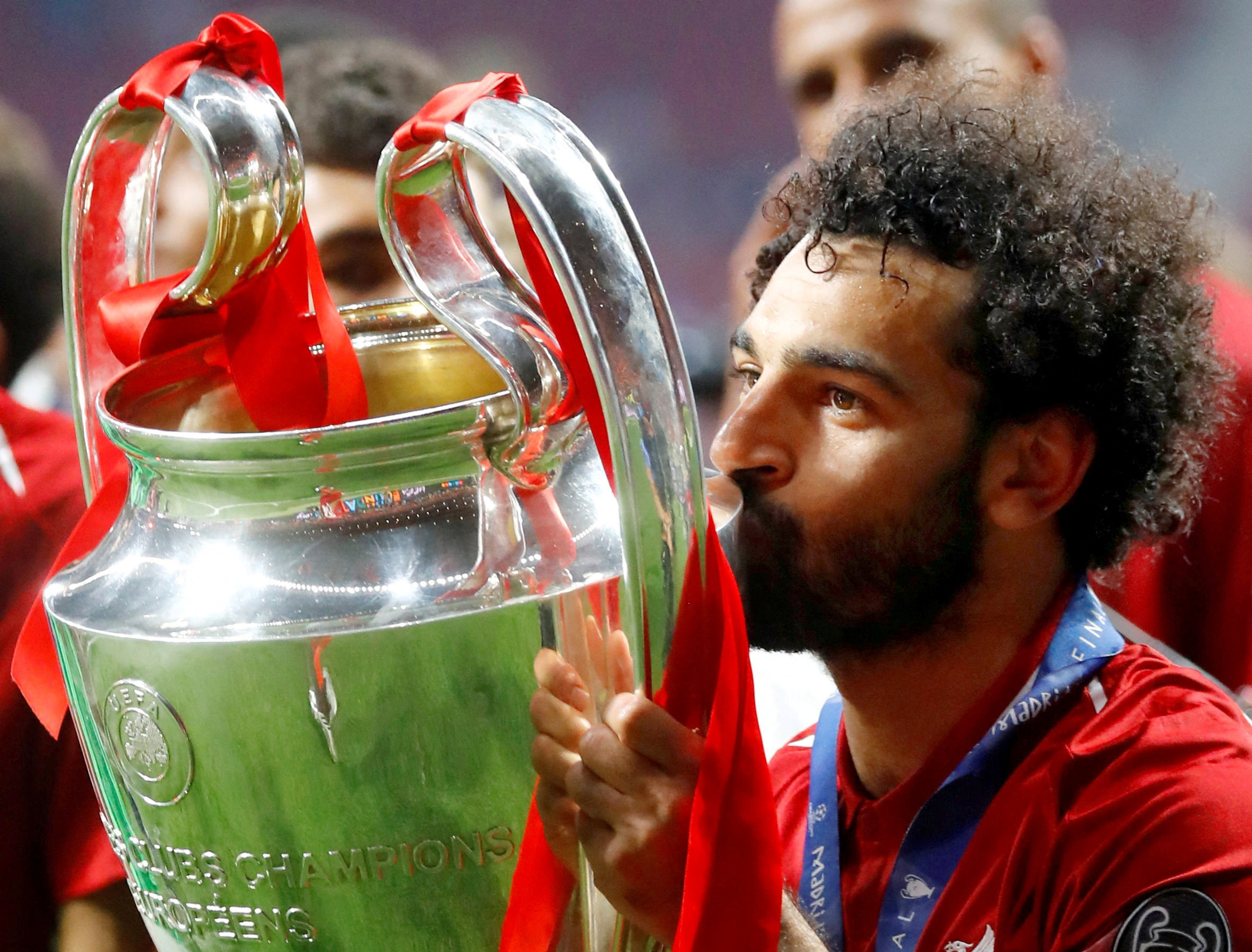 Liverpool's Mohamed Salah kisses the trophy as he celebrates after winning the Champions League