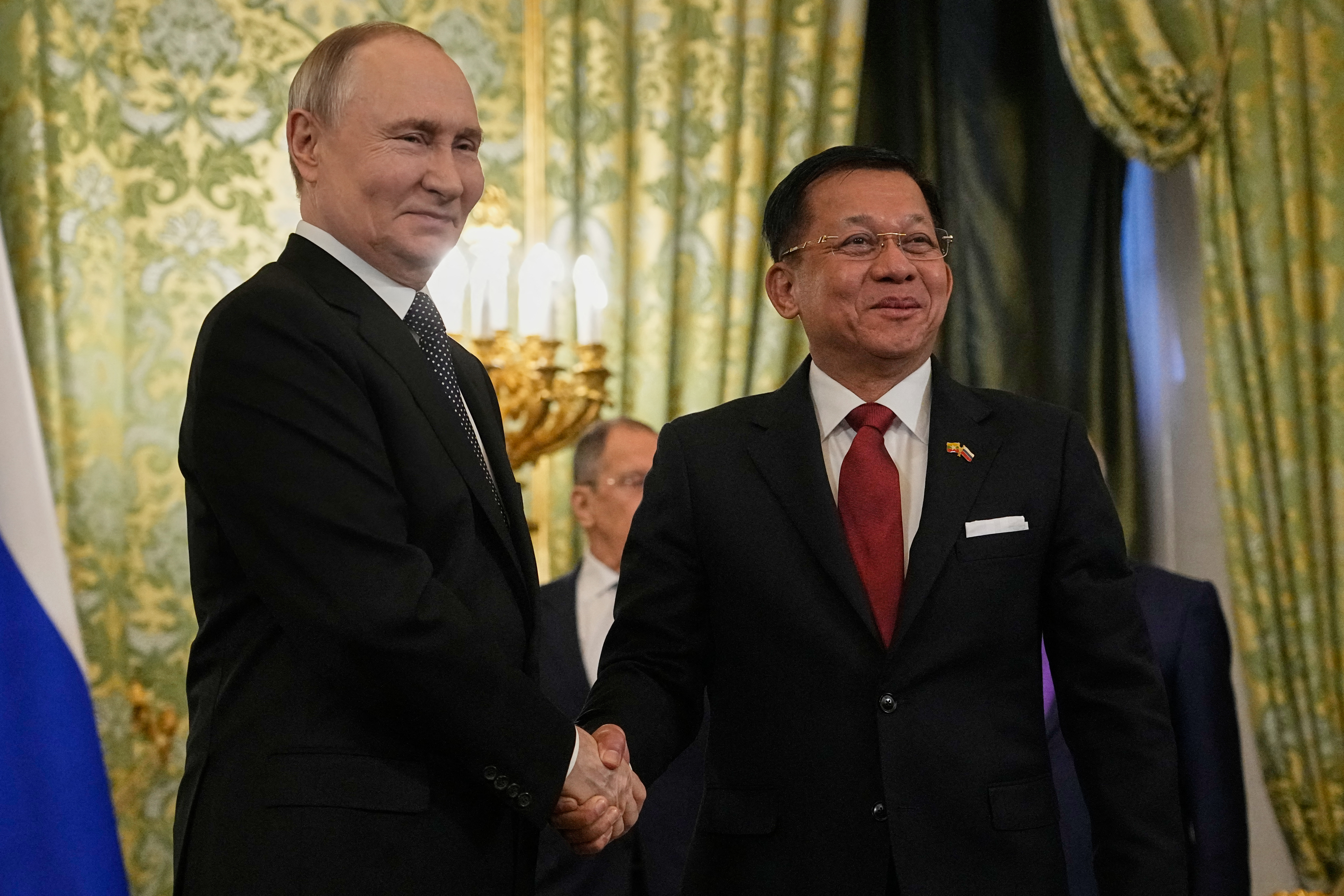 Russian President Vladimir Putin shakes hands with Myanmar's military chief Min Aung Hlaing