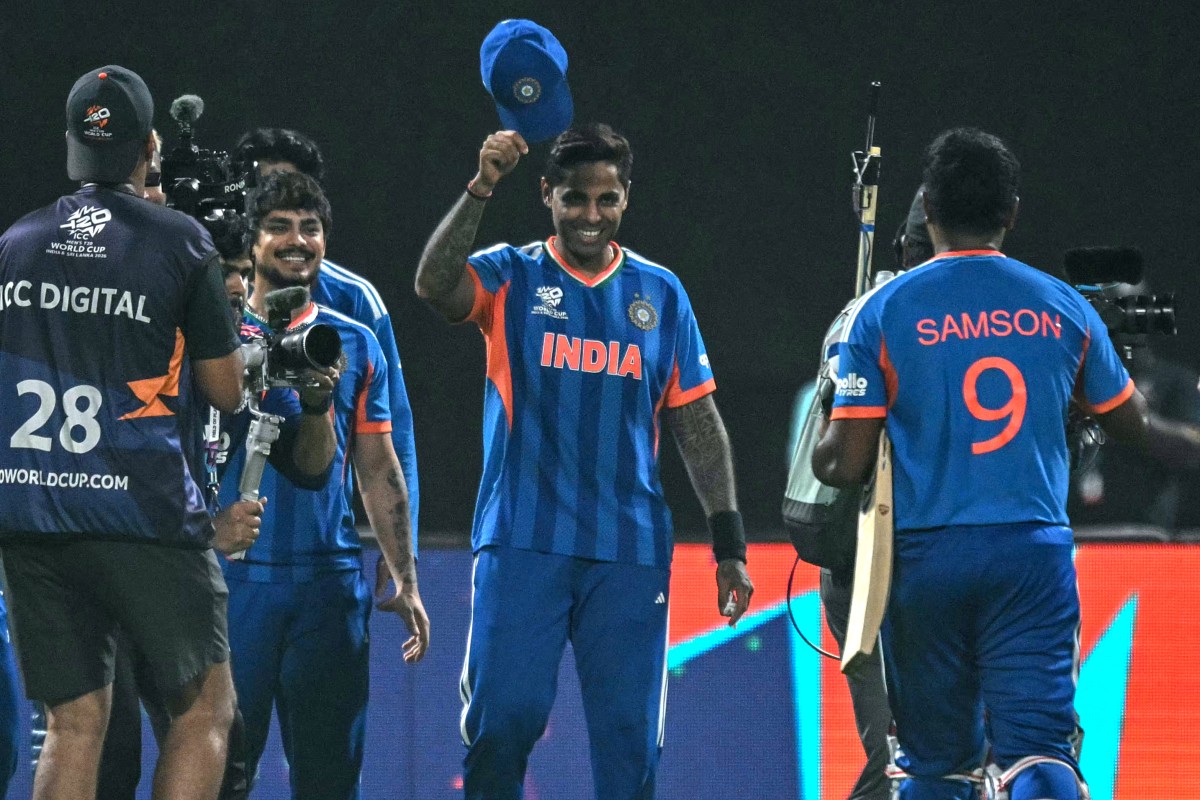 India's captain Suryakumar Yadav (C) greets his teammate Sanju Samson (R) after their team's win in the 2026 ICC Men's T20 Cricket World Cup Super Eights match between India and West Indies at the Eden Gardens in Kolkata on March 1, 2026. Sanju Samson's sparkling unbeaten 97 took India to a five-wicket win over the West Indies in Kolkata on March 1 to set up a T20 World Cup semi-final against England. (Photo by Arun SANKAR / AFP)