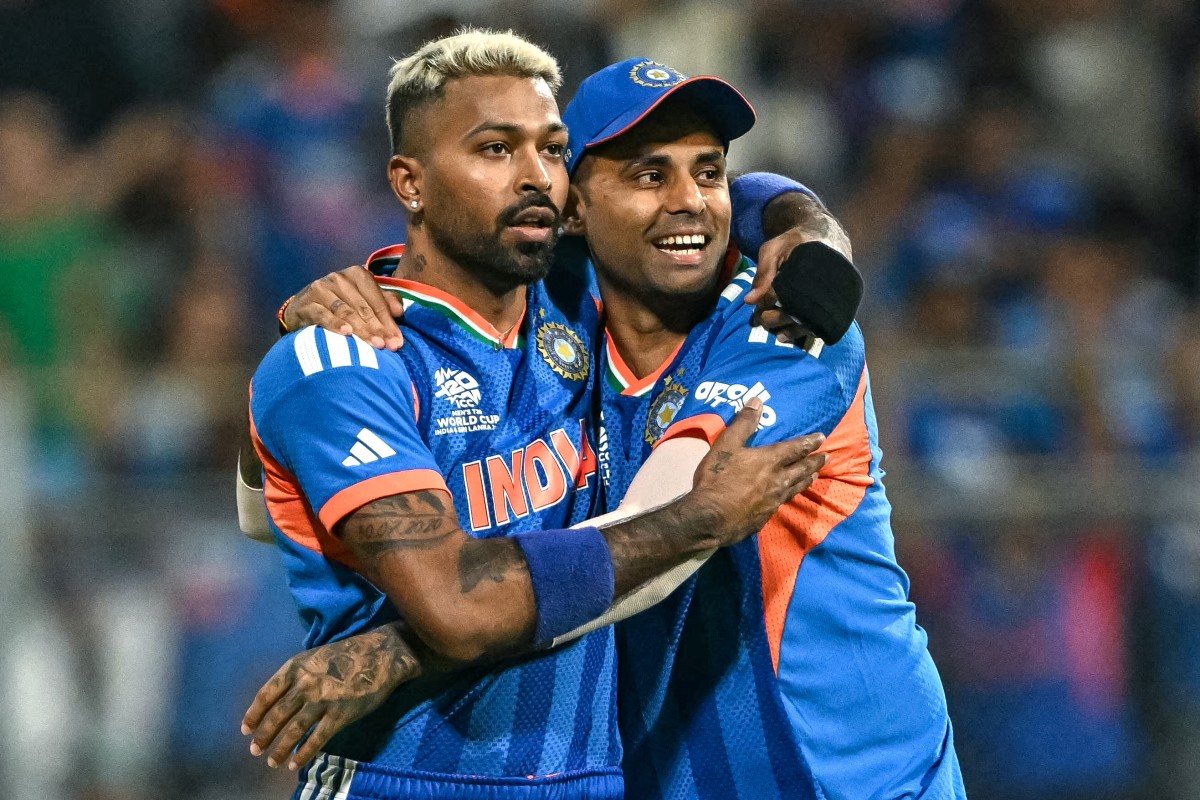 India's Hardik Pandya (L) celebrates with his captain Suryakumar Yadav after taking the wicket of England's Phil Salt during the 2026 ICC Men's T20 Cricket World Cup semi-final
