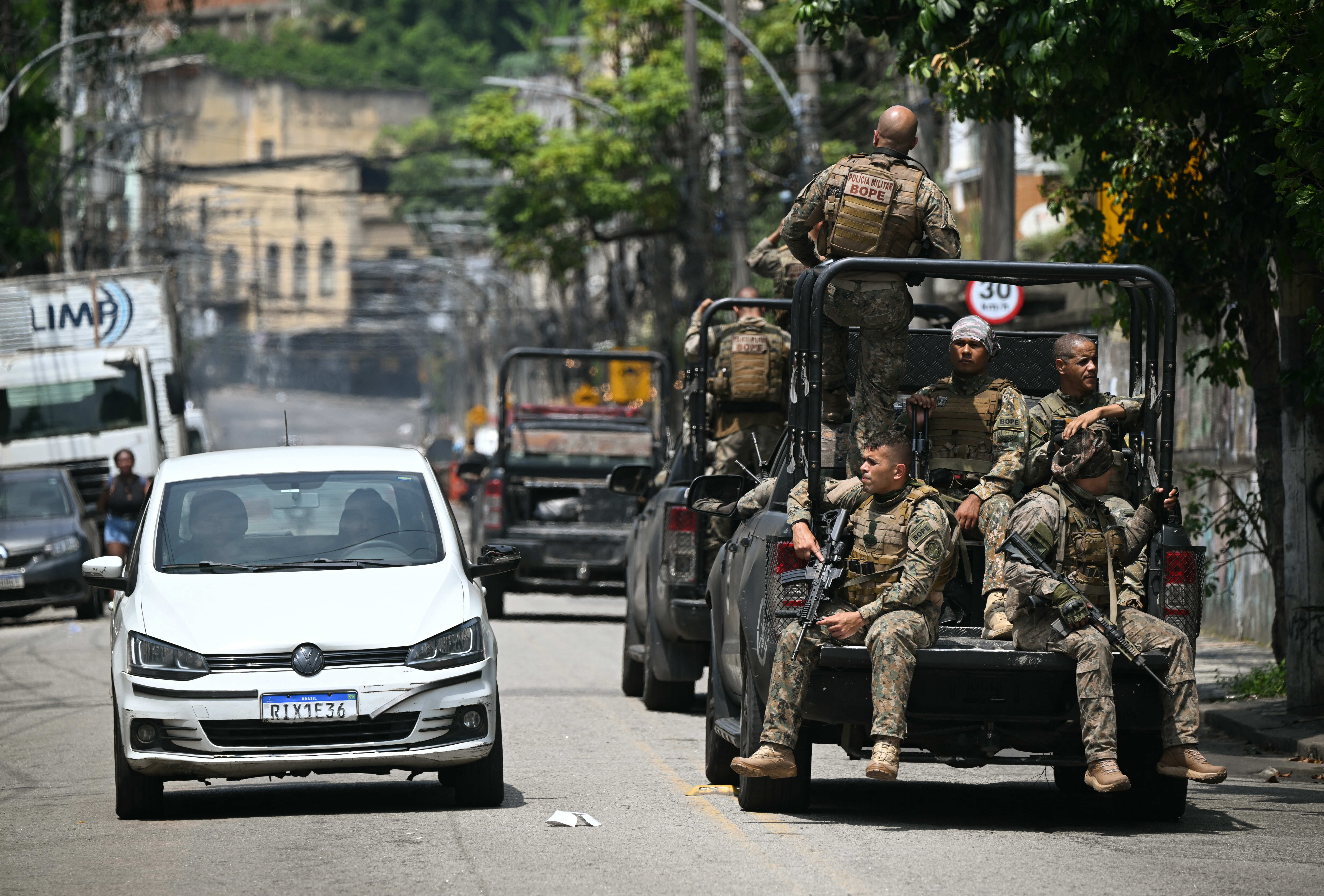 Armed police in the back of a truck