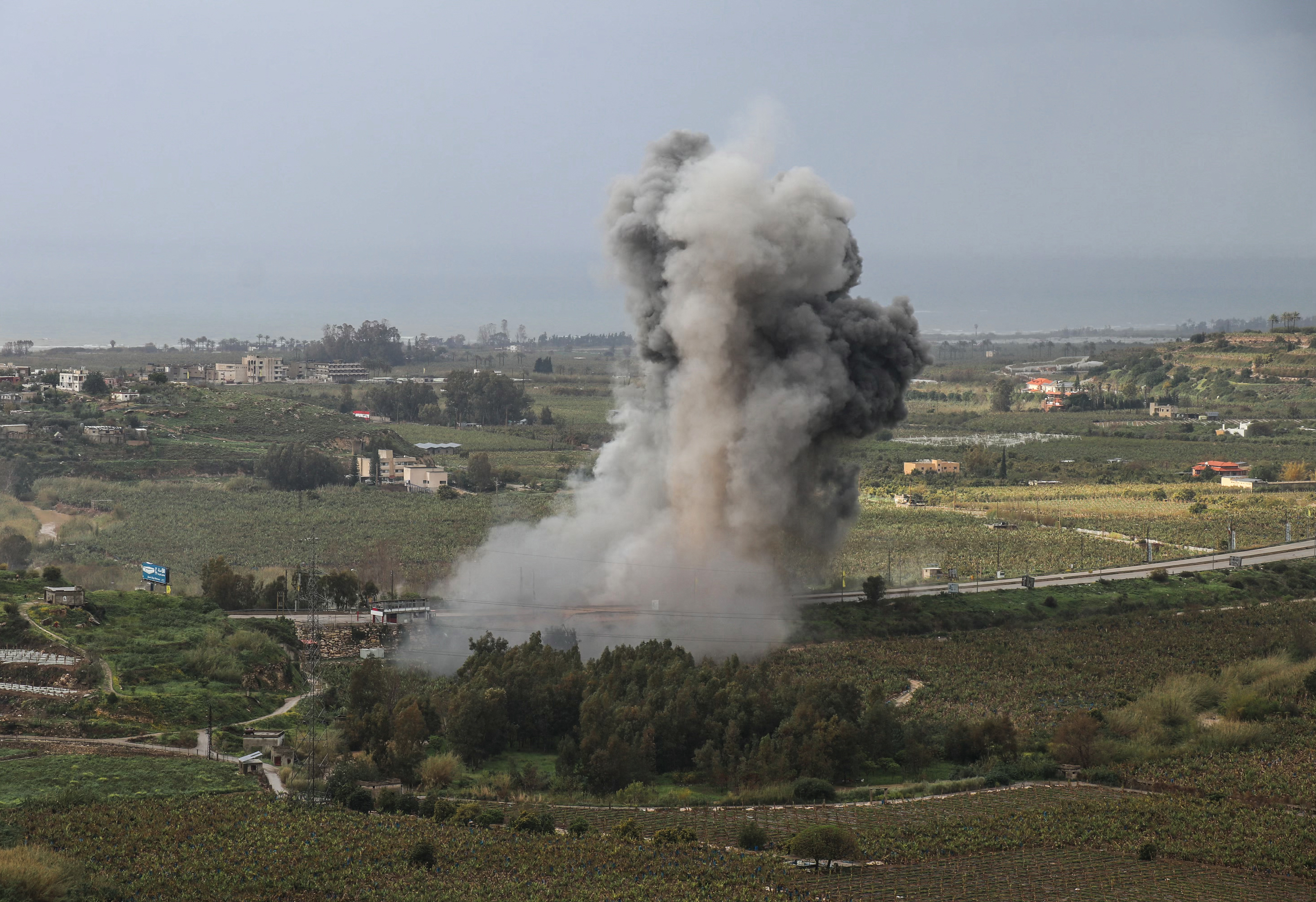 Smoke rises from the site of an Israeli airstrike that targeted the Qasmiyeh bridge
