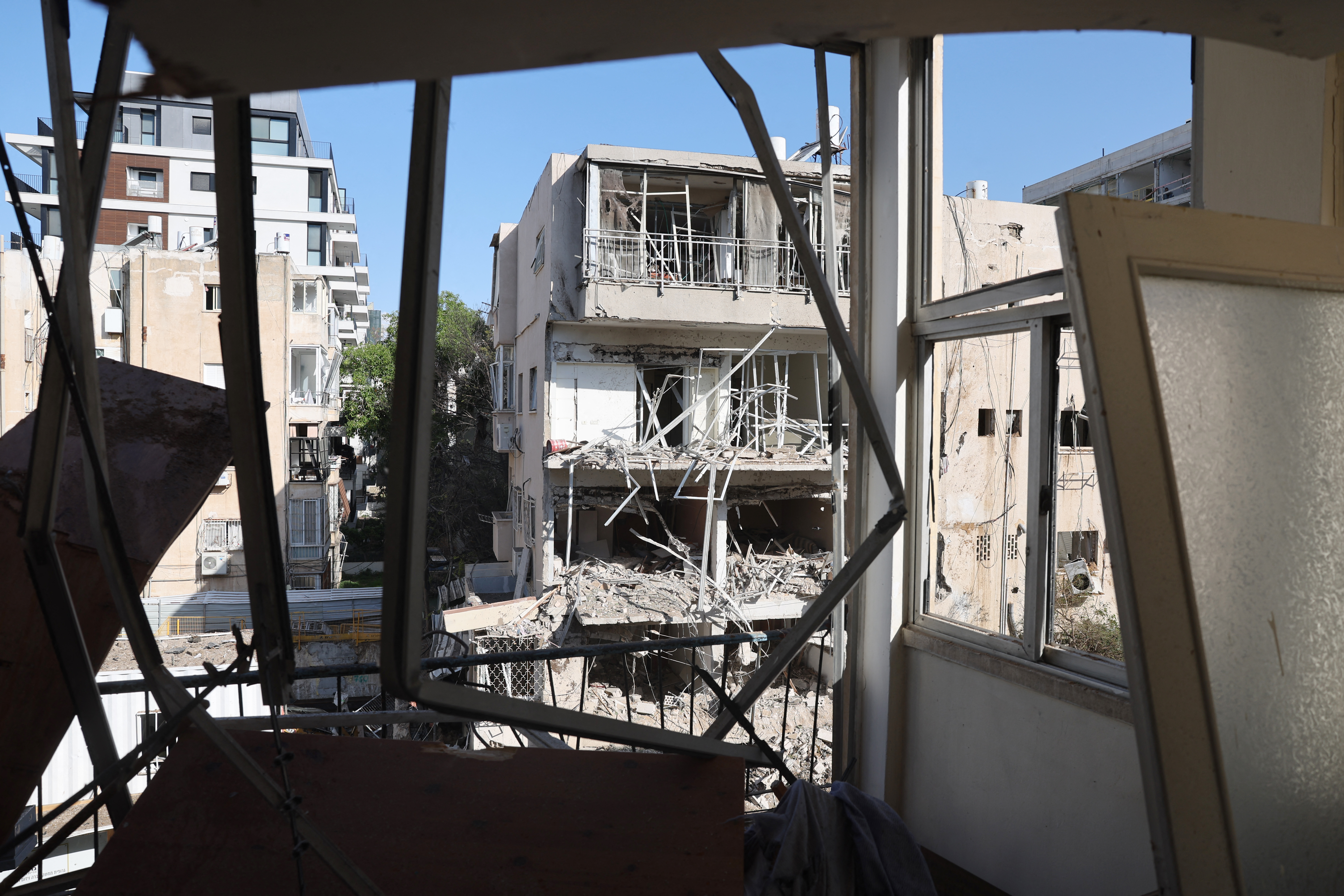 This picture shows damaged buildings at the site of an Iranian missile strike in Tel Aviv
