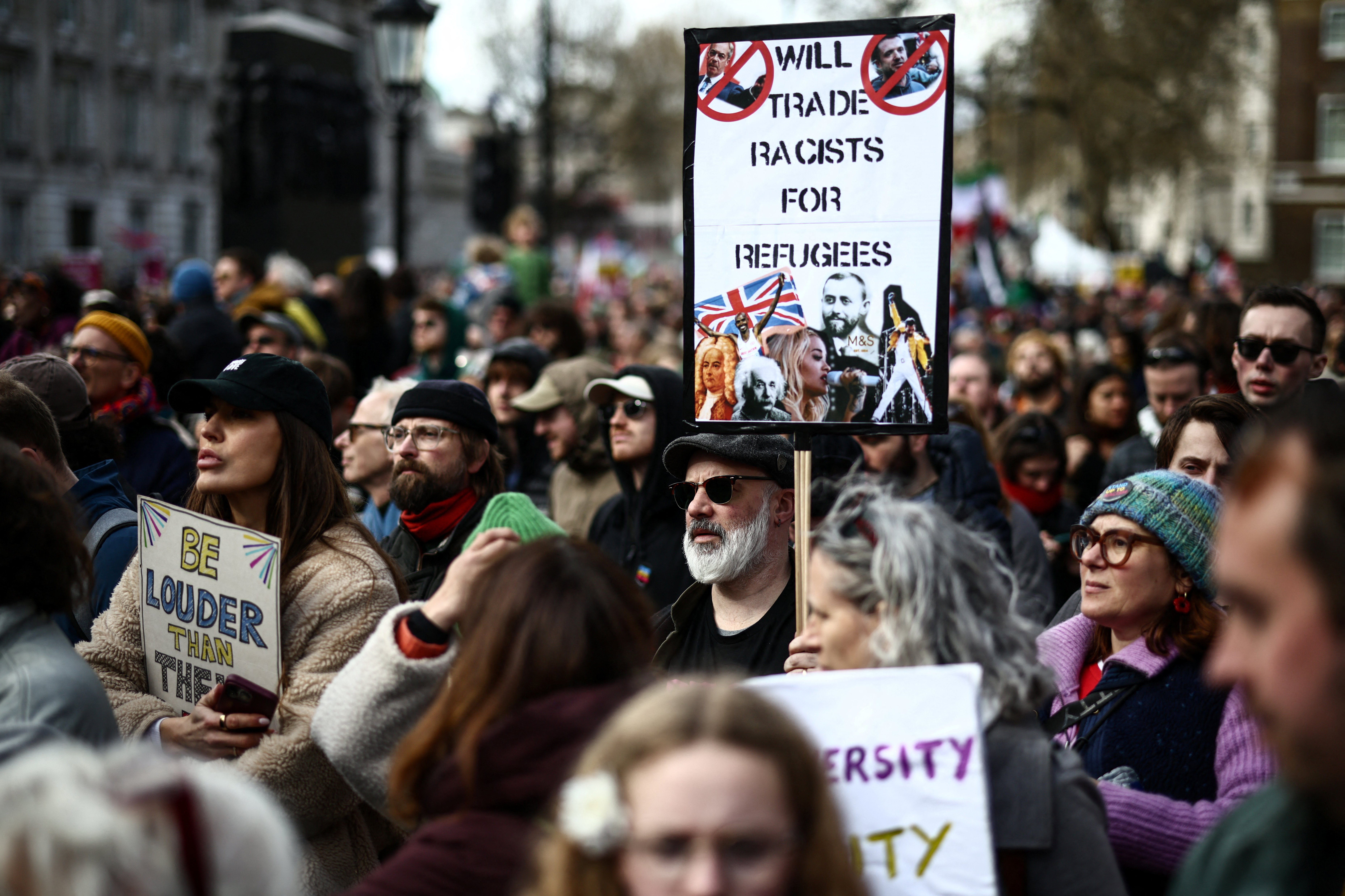 Protesters holding placards gather ahead of speeches after a march against the far right, organised by the Together Alliance, in central London on March 28, 2026. (Photo by Henry NICHOLLS / AFP)