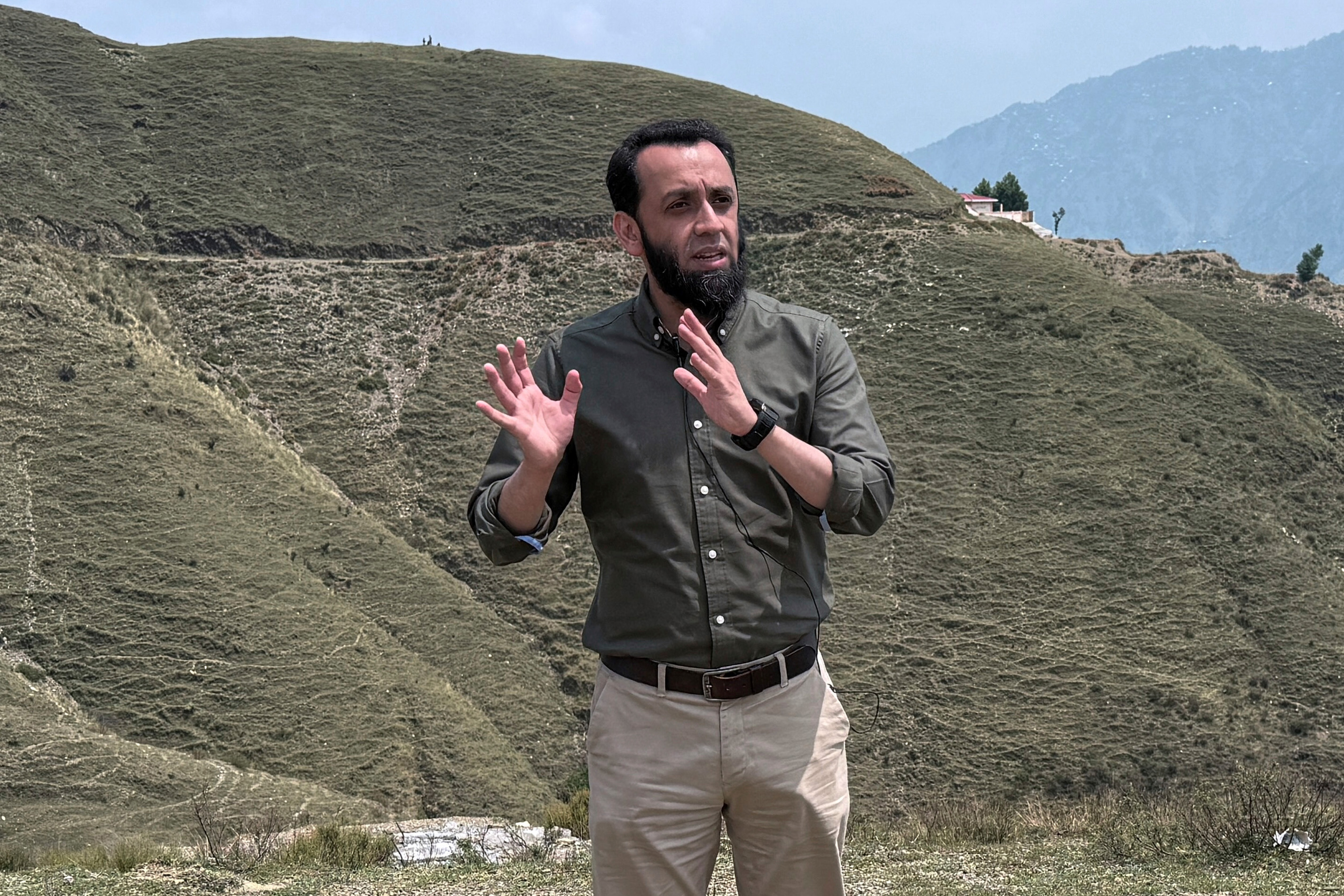 Pakistan's Information Minister Attaullah Tarar, center, briefs journalists during a government's organized trip for media to Bella Noor Shah, a mountainous village near Muzaffarabad, the capital of Pakistan administered Kashmir, Monday, May 5, 2025. [Muhammad Yousuf via AP Photo]