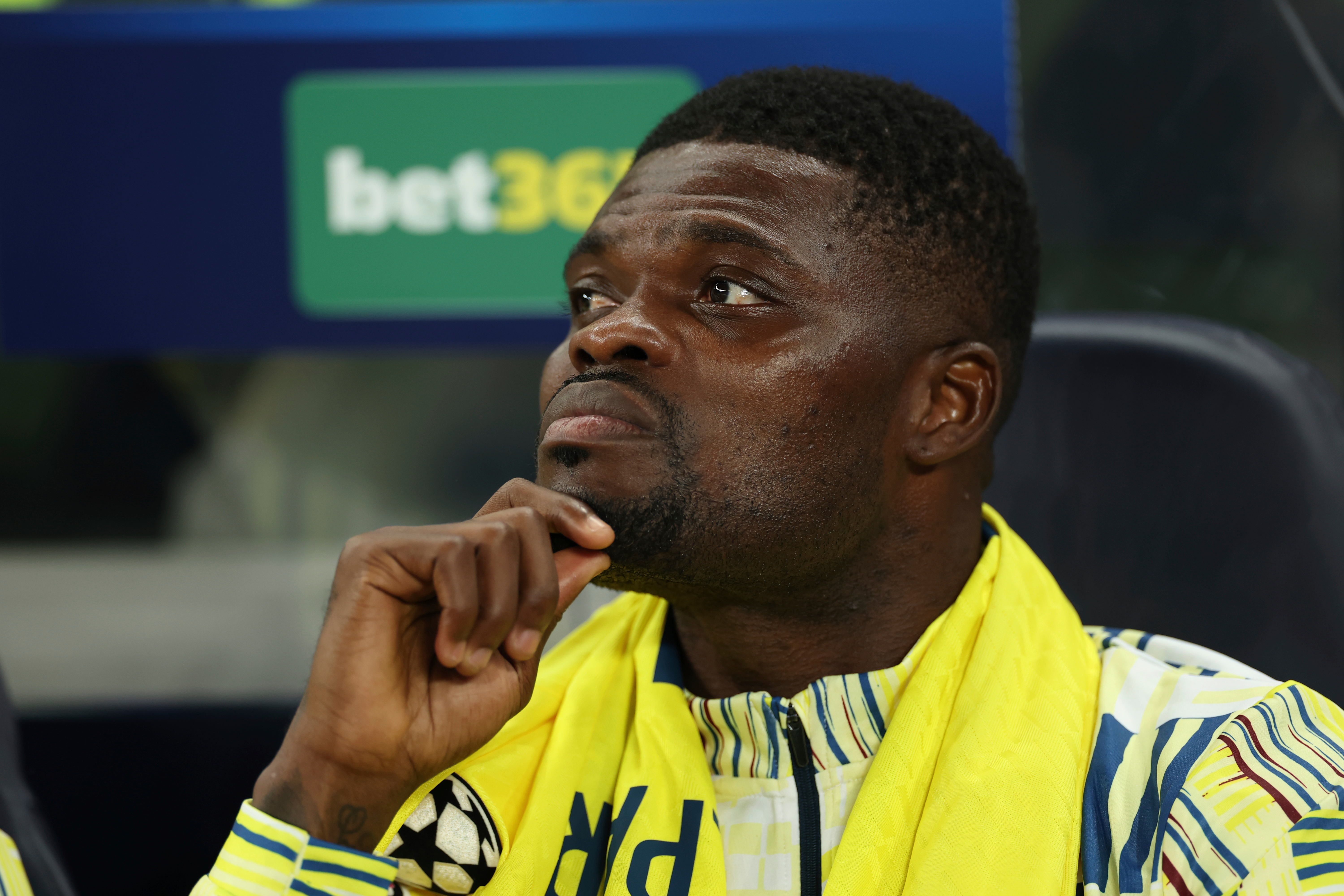 Villarreal's Thomas Partey sits on the bench during the Champions League soccer match between Tottenham and Villarreal in London