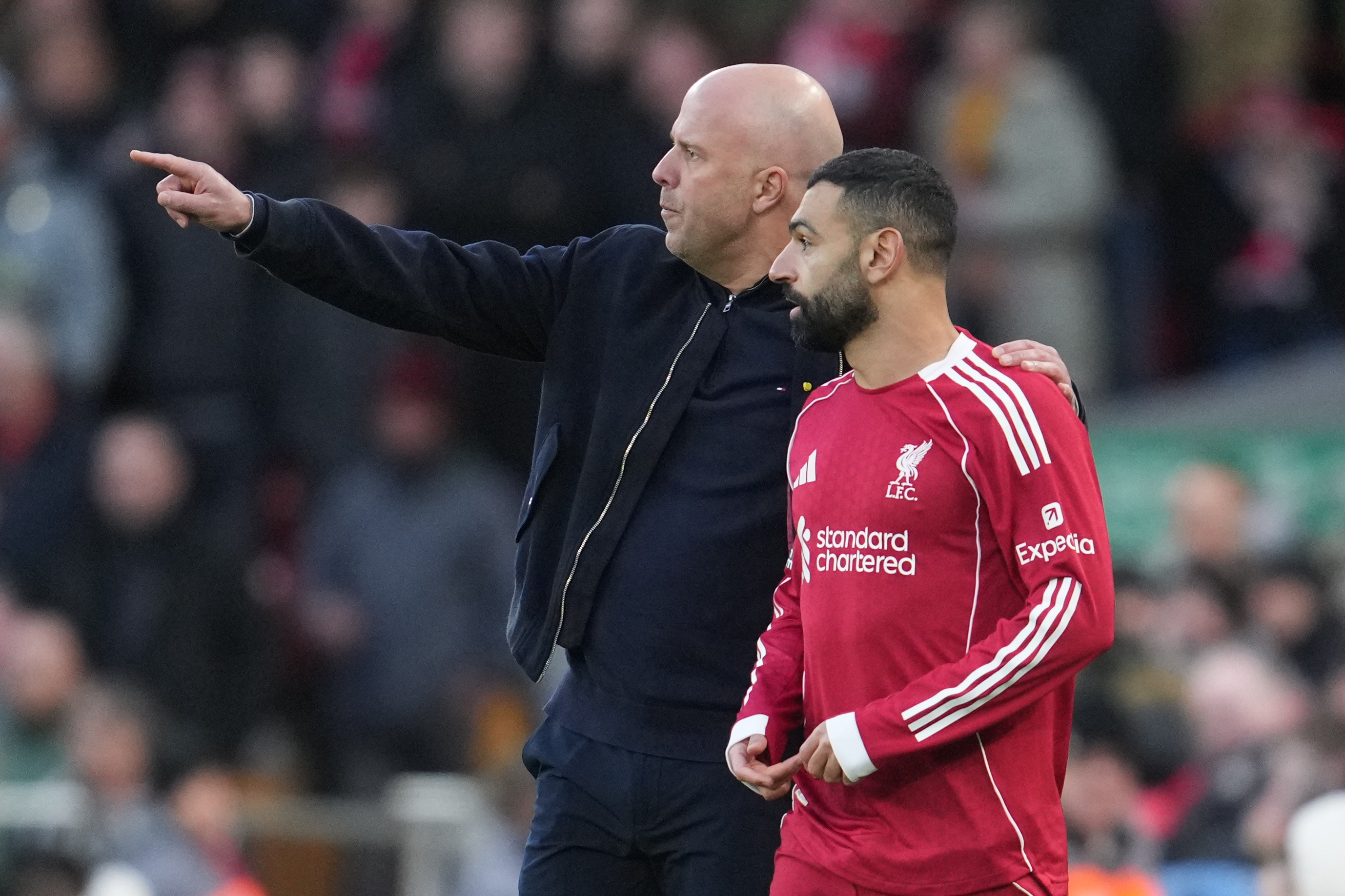 Liverpool manager Arne Slot, left, with Mohamed Salah on the pitch.