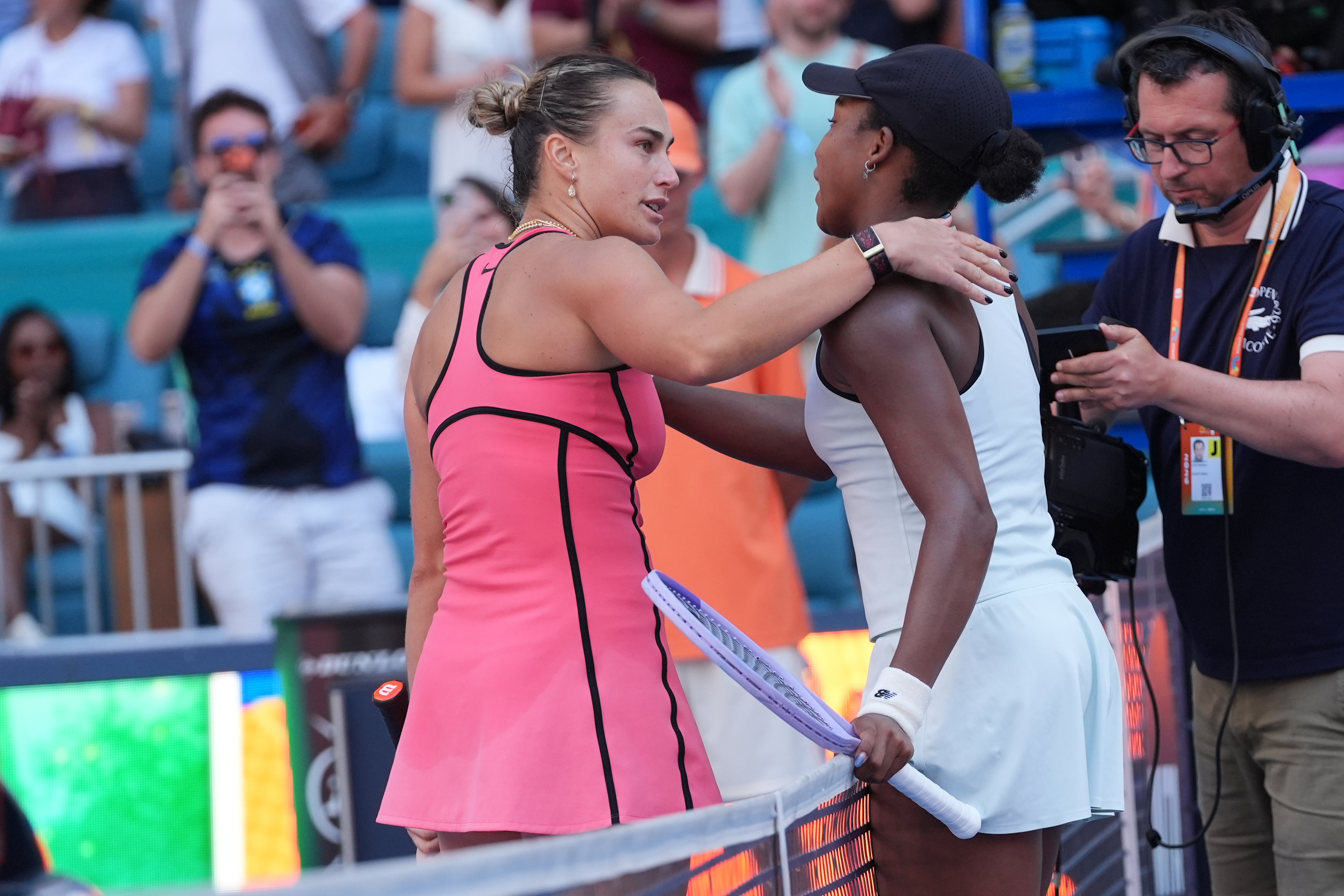 Aryna Sabalenka and Coco Gauff react. 