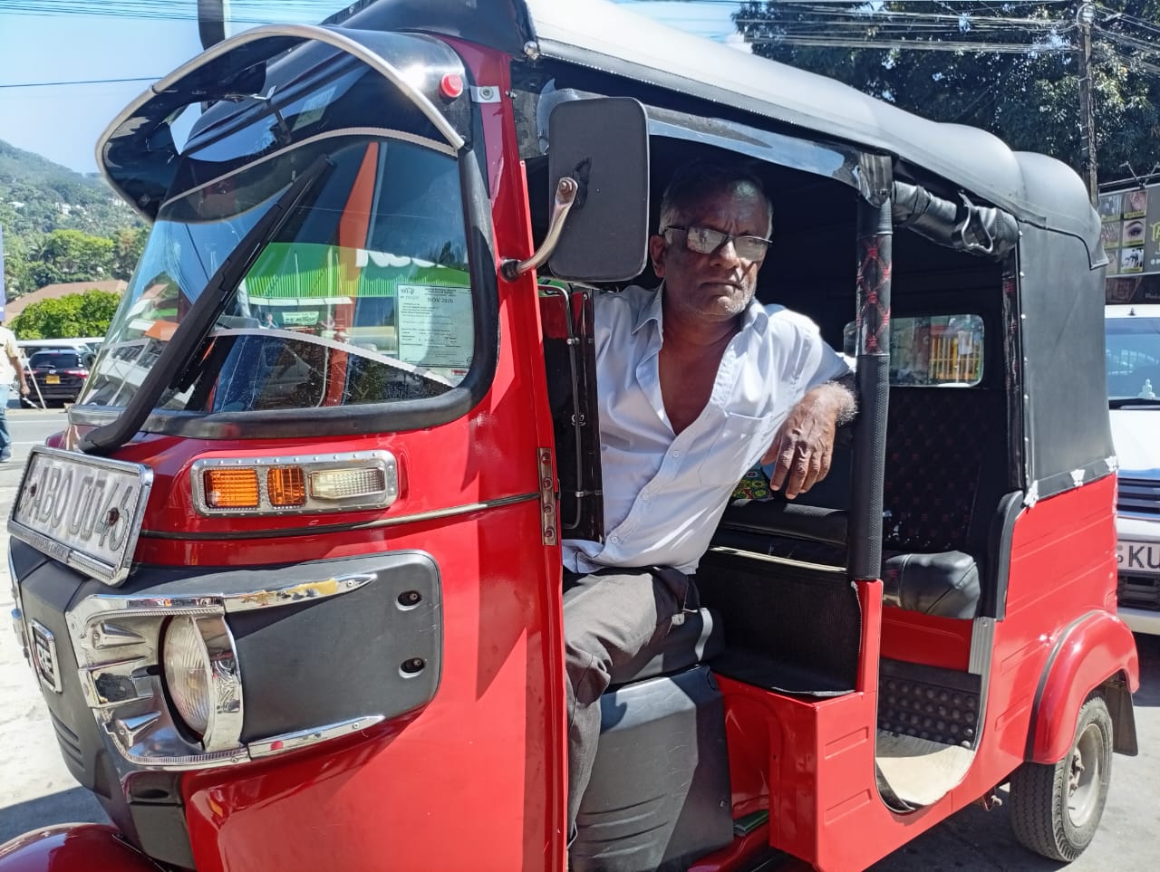 Keerthi Rathna, a tuk tik driver, in a queue to fill fuel at a gas station in Kandy, Sri Lanka