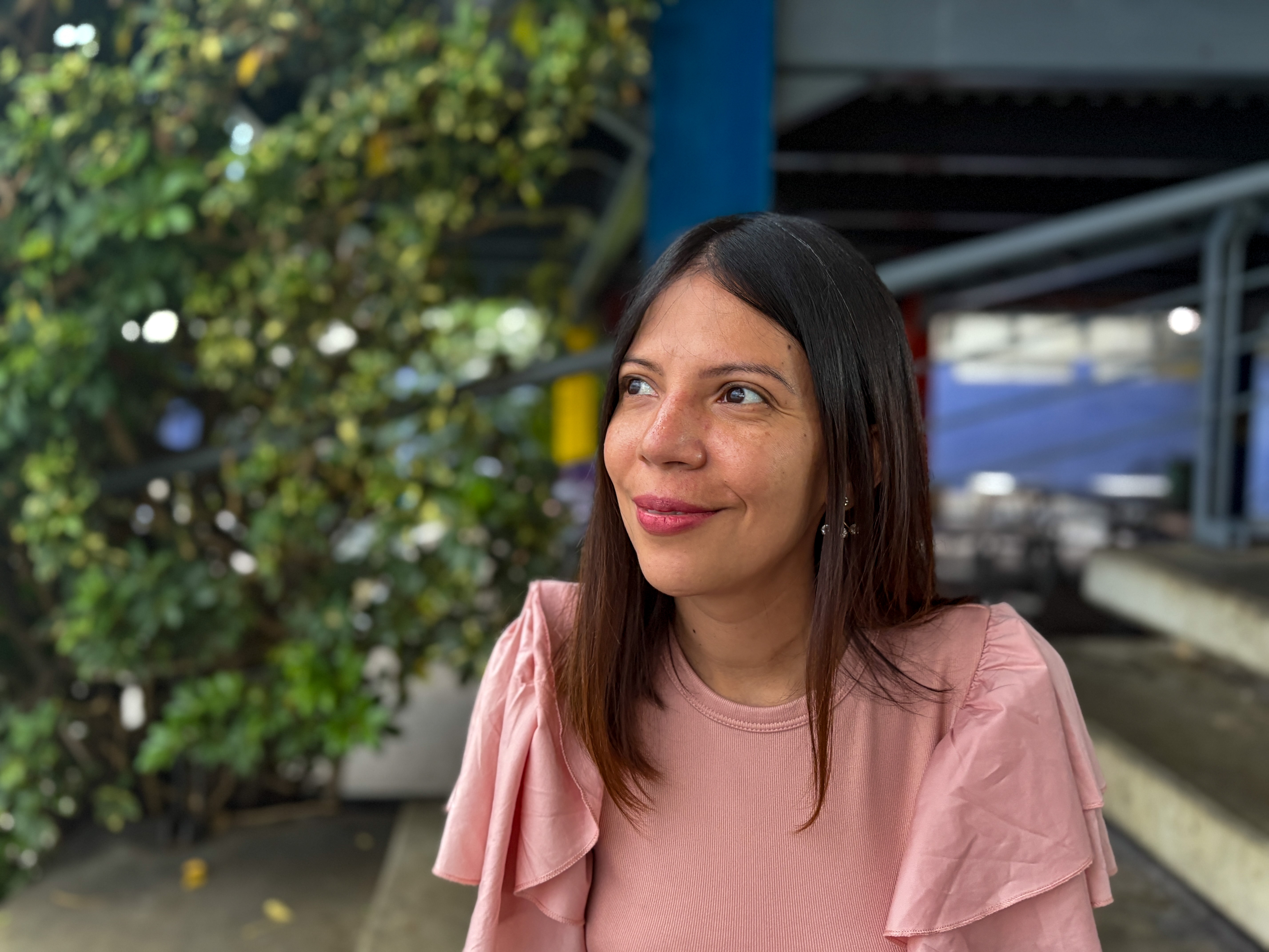 Libertad Velasco sits in a pink shirt
