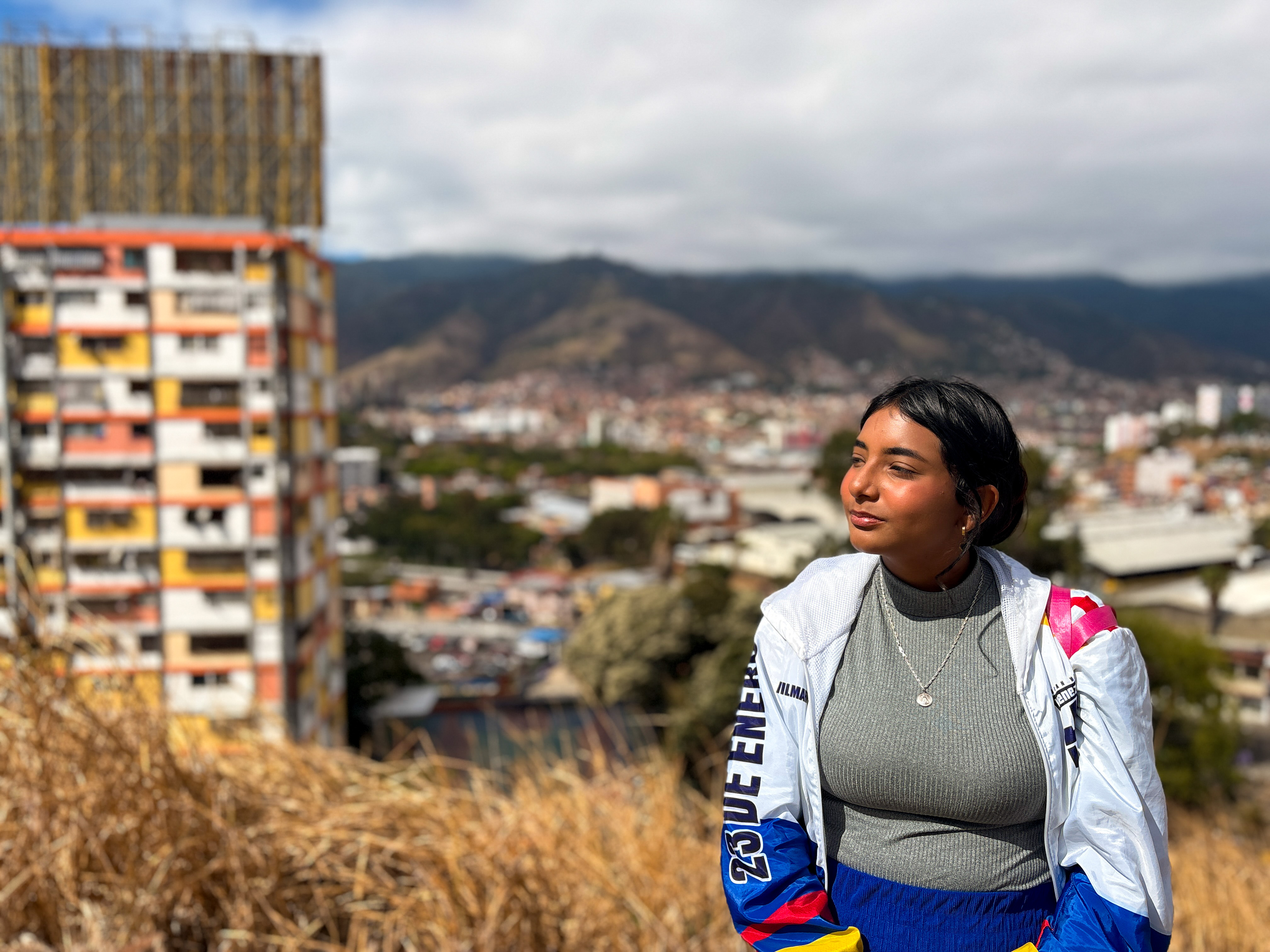 Wilmar Oca stands in the hills above the 23 de Enero neighbourhood of Caracas, Venezuela [Catherine Ellis/Al Jazeera]
