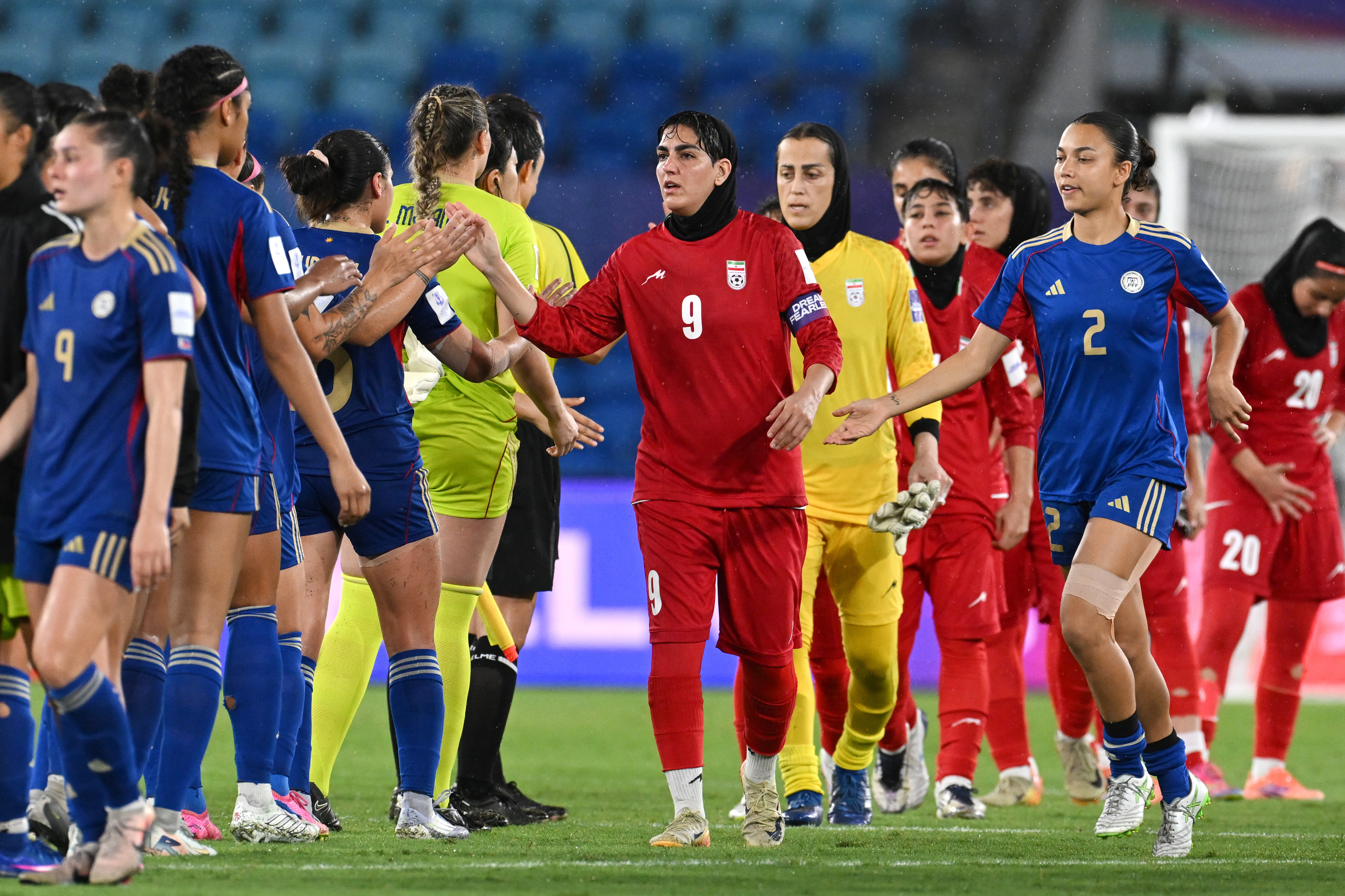 Iran's Zahra Ghanbari, center, gestures to the Philippines players following the Women's Asian Cup soccer match between Iran and the Philippines in Robina, Australia, Sunday, March 8, 2026. (Dave Hunt/AAPImage via AP)