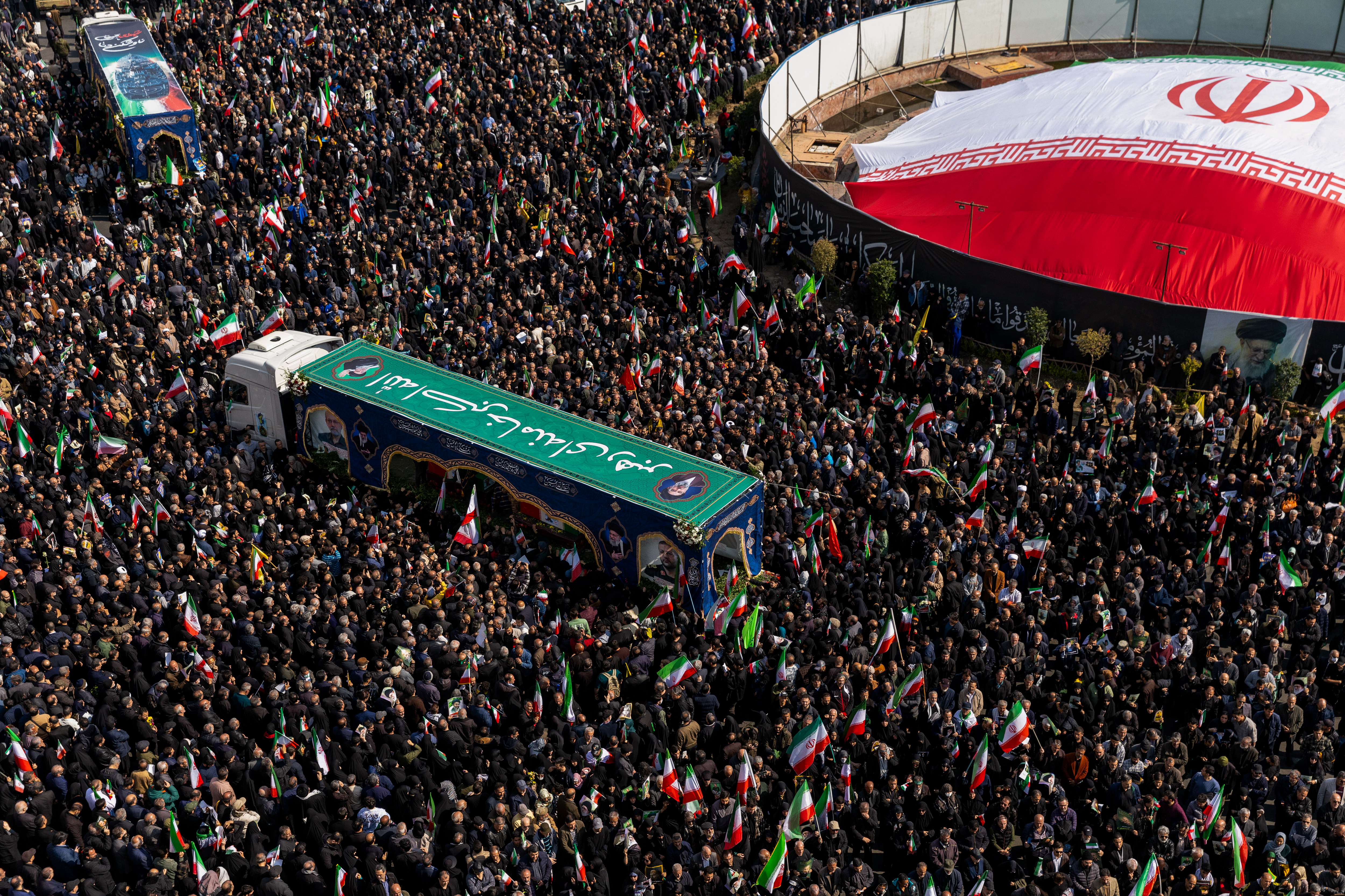 TEHRAN, IRAN - MARCH 18: Large crowds gather during a joint funeral held for Ali Larijani, Secretary of Iran's Supreme National Security Council, Basij commander Major General Gholam Soleimani, and 84 sailors from the Iranian Navy frigate IRIS Dena, on March 18, 2026 in Tehran, Iran. Larijani and Gholamreza, two of the highest-ranking Iranian officials to be assassinated since the outbreak of the war on February 28, were killed in US-Israeli airstrikes on March 17, according to Iranian state media. The 84 sailors were killed when the IRIS Dena was sunk in a torpedo strike by the USSCharlotte, an American submarine,off the coast of Sri Lanka on March 4. (Photo by Majid Saeedi/Getty Images)