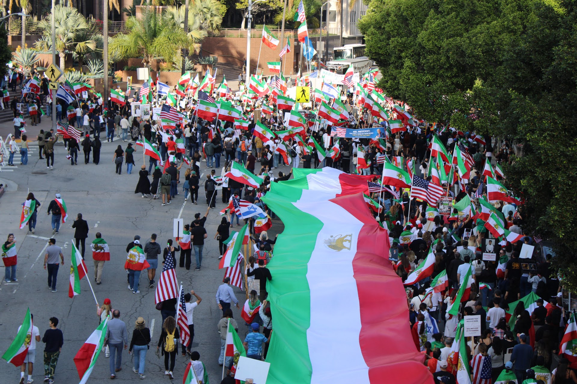 Protesters stretch out a giant Iranian "lion and sun" flag during a protest in Los Angeles