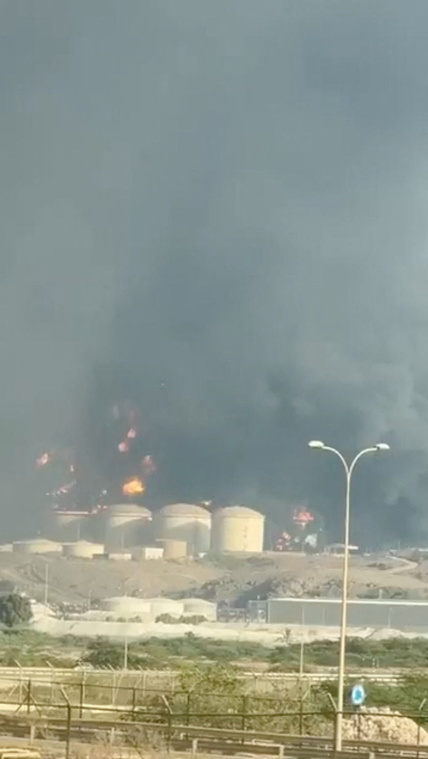 A plume of smoke raises from oil storage facilities at the Port of Salalah in Raysut, Oman in this screen capture from video obtained from social media and released March 11, 2026. Social Media/Handout via REUTERS THIS IMAGE HAS BEEN SUPPLIED BY A THIRD PARTY. NO RESALES. NO ARCHIVES. MANDATORY CREDIT. Verification: Road layout, silos and utility poles matched file and satellite imagery. Date not verified but no older version of the videos was found posted online before March 11, 2026. Maritime security firm Ambrey said oil storage facilities were struck in Salalah port on March 11, reported by Reuters