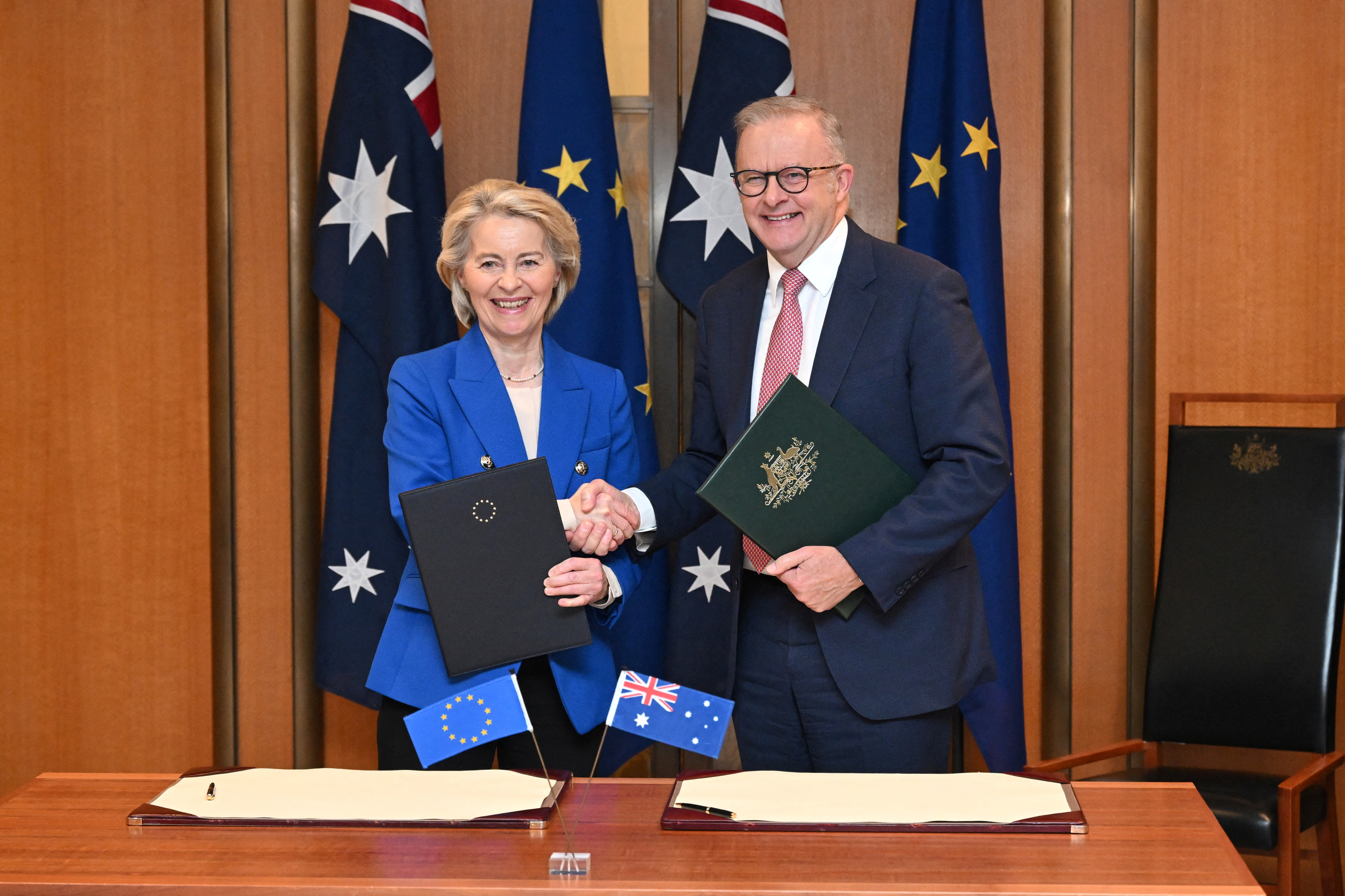 President of the European Commission Ursula von der Leyen and Australian Prime Minister Anthony Albanese pose with a signed joint statement.