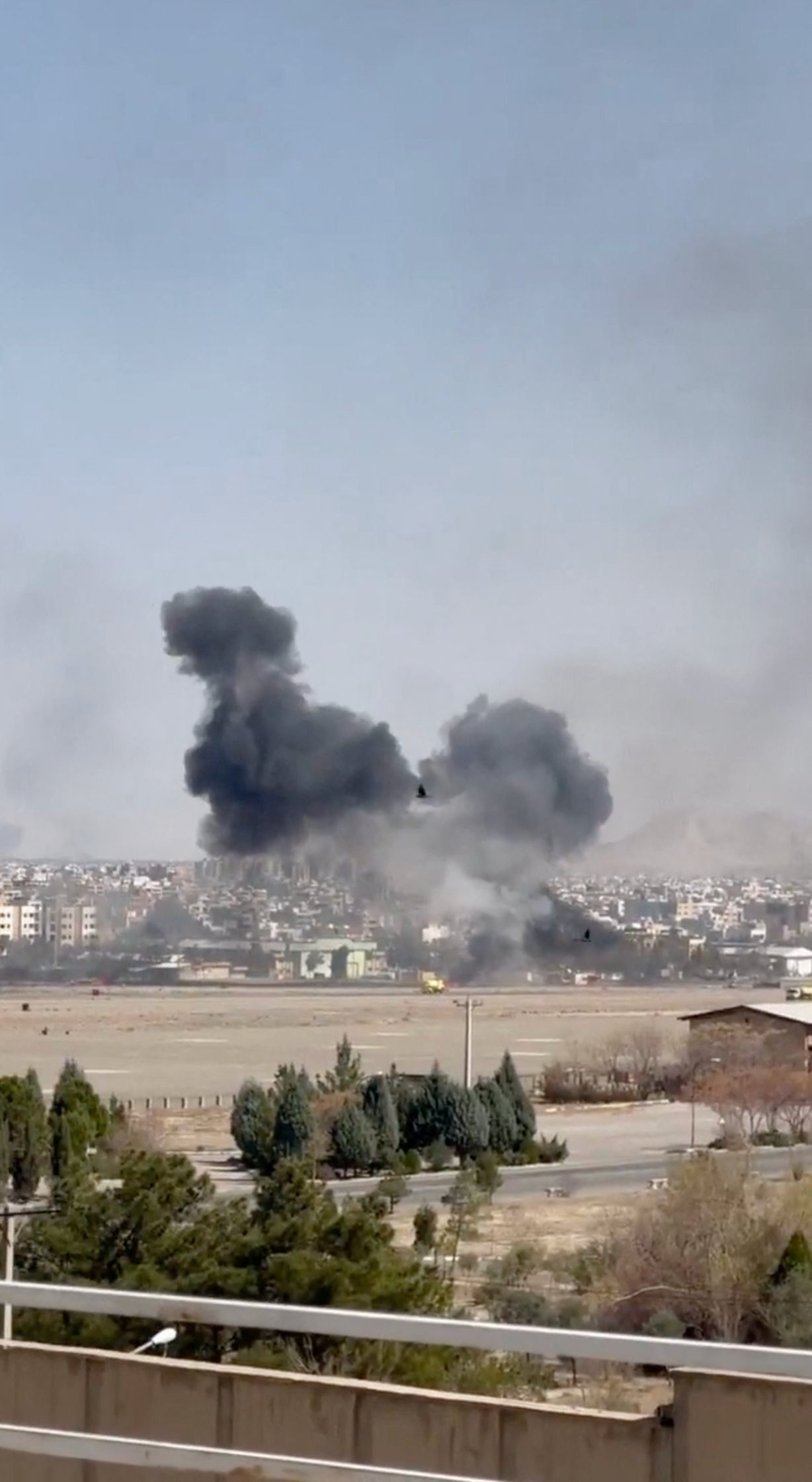 Smoke rises following explosions at an airfield in Isfahan on March 7