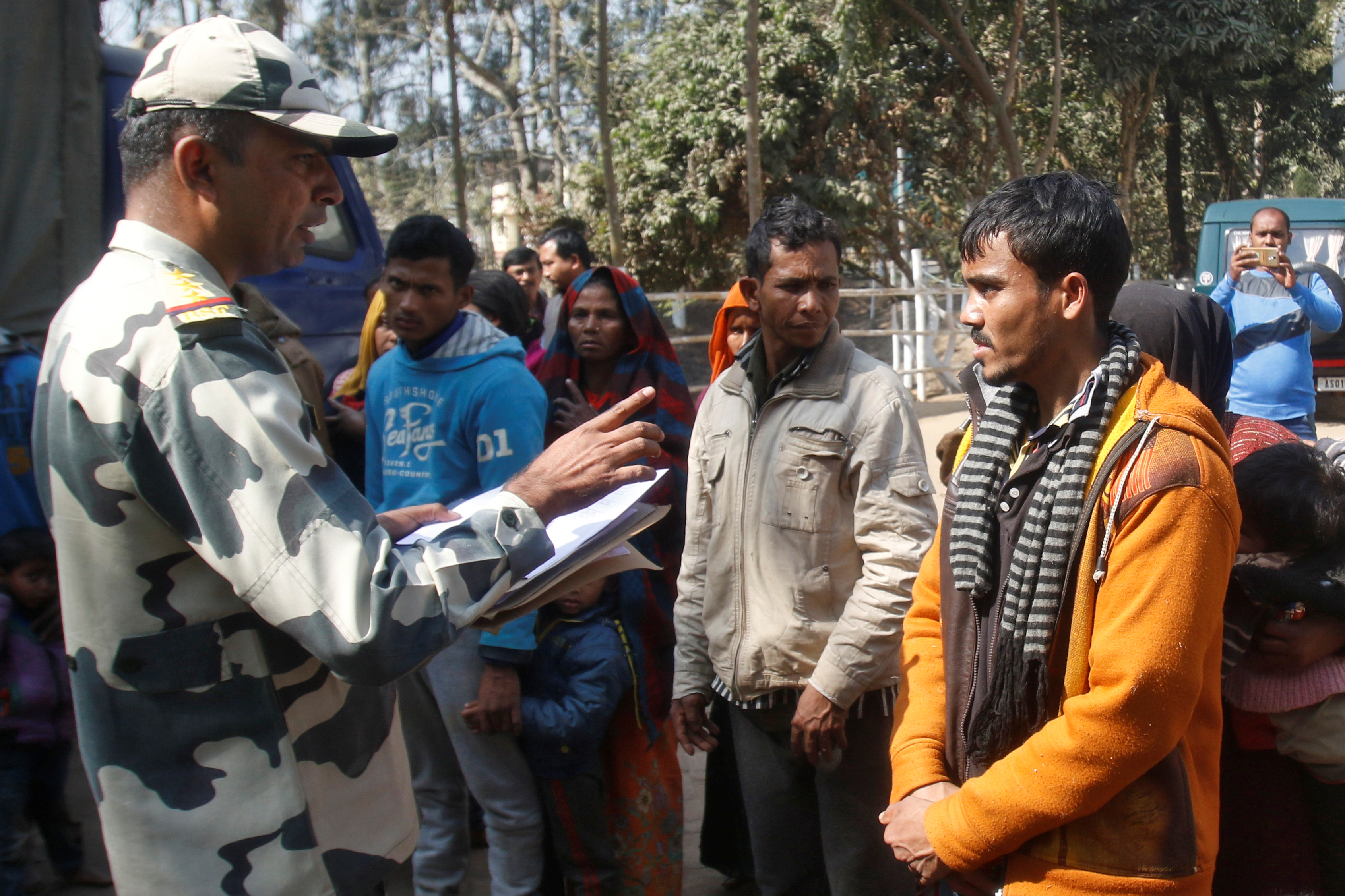 A Border Security Force (BSF) official registers the names of Muslim-majority Rohingya after they were detained while crossing the India-Bangladesh border from Bangladesh, at Raimura village on the outskirts of Agartala, on January 22, 2019
