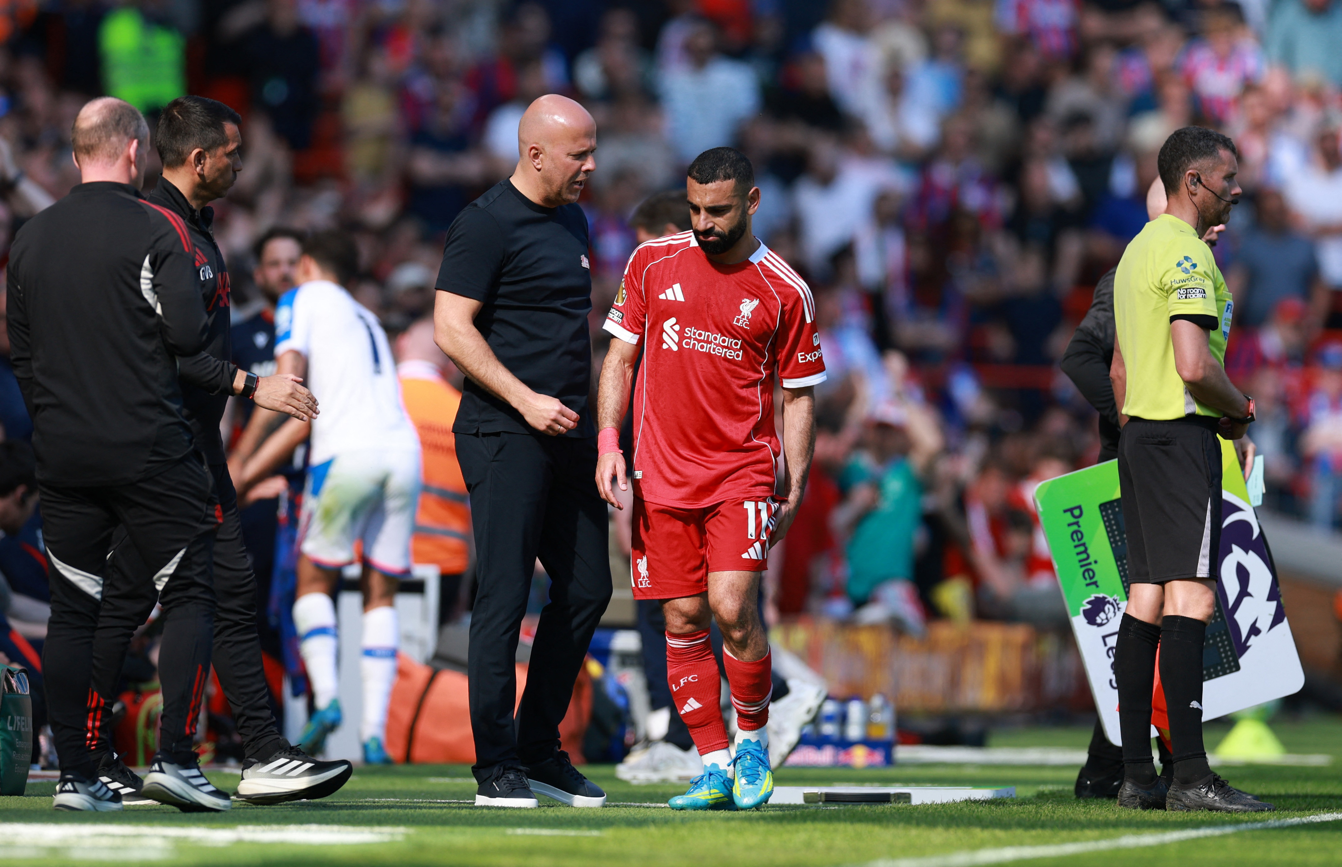 Soccer Football - Premier League - Liverpool v Crystal Palace - Anfield, Liverpool, Britain - April 25, 2026 Liverpool's Mohamed Salah with manager Arne Slot after being substituted REUTERS/Phil Noble EDITORIAL USE ONLY. NO USE WITH UNAUTHORIZED AUDIO, VIDEO, DATA, FIXTURE LISTS, CLUB/LEAGUE LOGOS OR 'LIVE' SERVICES. ONLINE IN-MATCH USE LIMITED TO 120 IMAGES, NO VIDEO EMULATION. NO USE IN BETTING, GAMES OR SINGLE CLUB/LEAGUE/PLAYER PUBLICATIONS. PLEASE CONTACT YOUR ACCOUNT REPRESENTATIVE FOR FURTHER DETAILS..