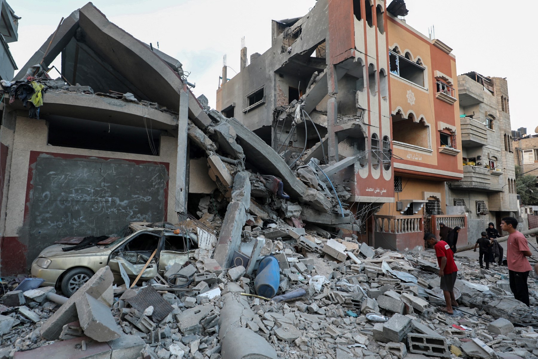 Palestinians check the rubble of buildings hit by an Israeli attack in the Nuseirat refugee camp during Israel’s ground offensive to capture nearby Gaza City on September 25, 2025