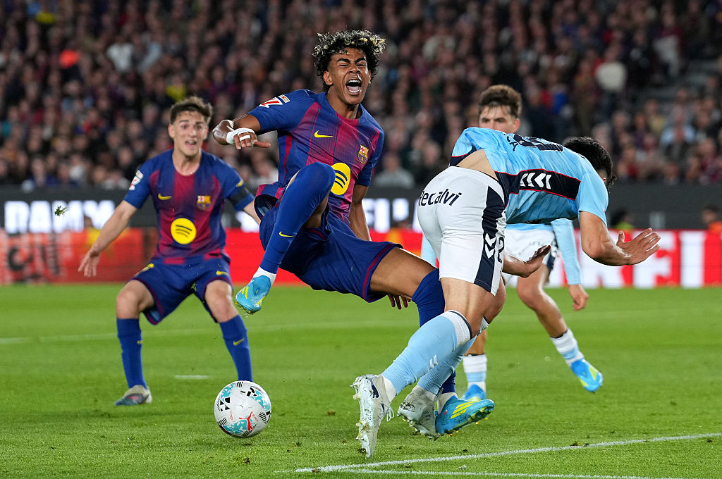 Yoel Lago of Celta Vigo fouls Lamine Yamal of Barcelona, leading to a penalty during the La Liga match