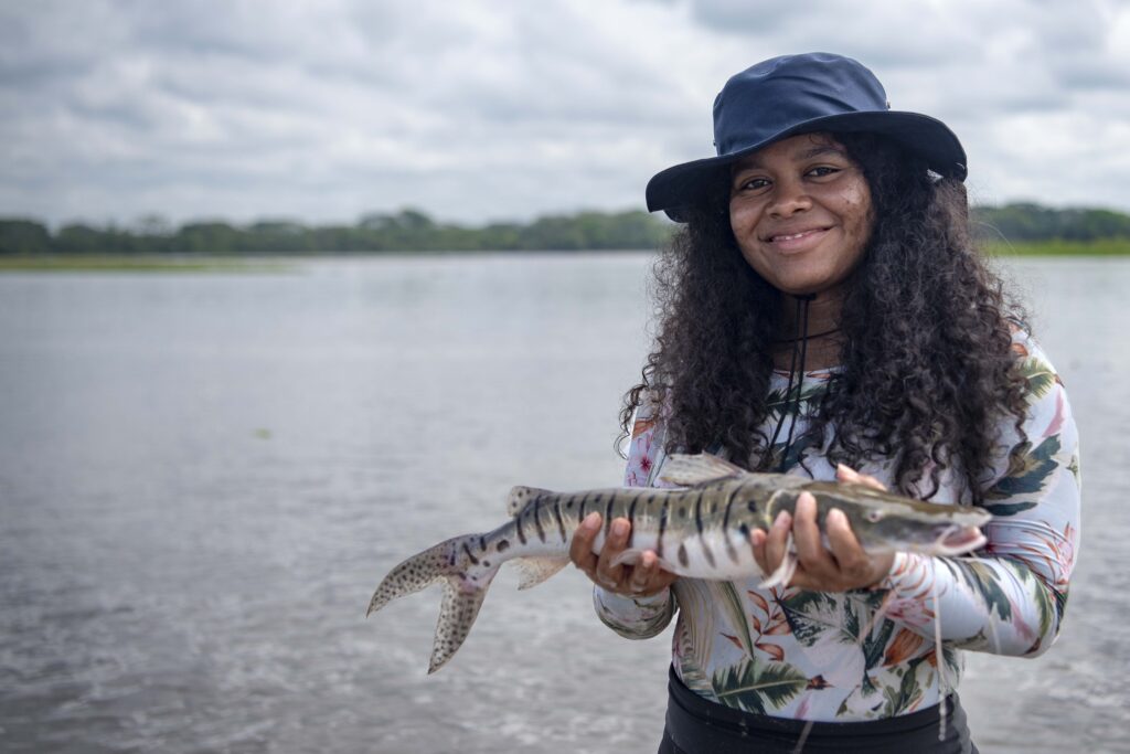 Yuvelis Morales Blanco, winner of the 2026 Goldman Environmental Prize, shows a fish caught on a tour with fishermen along the Magdalena River in Colombia