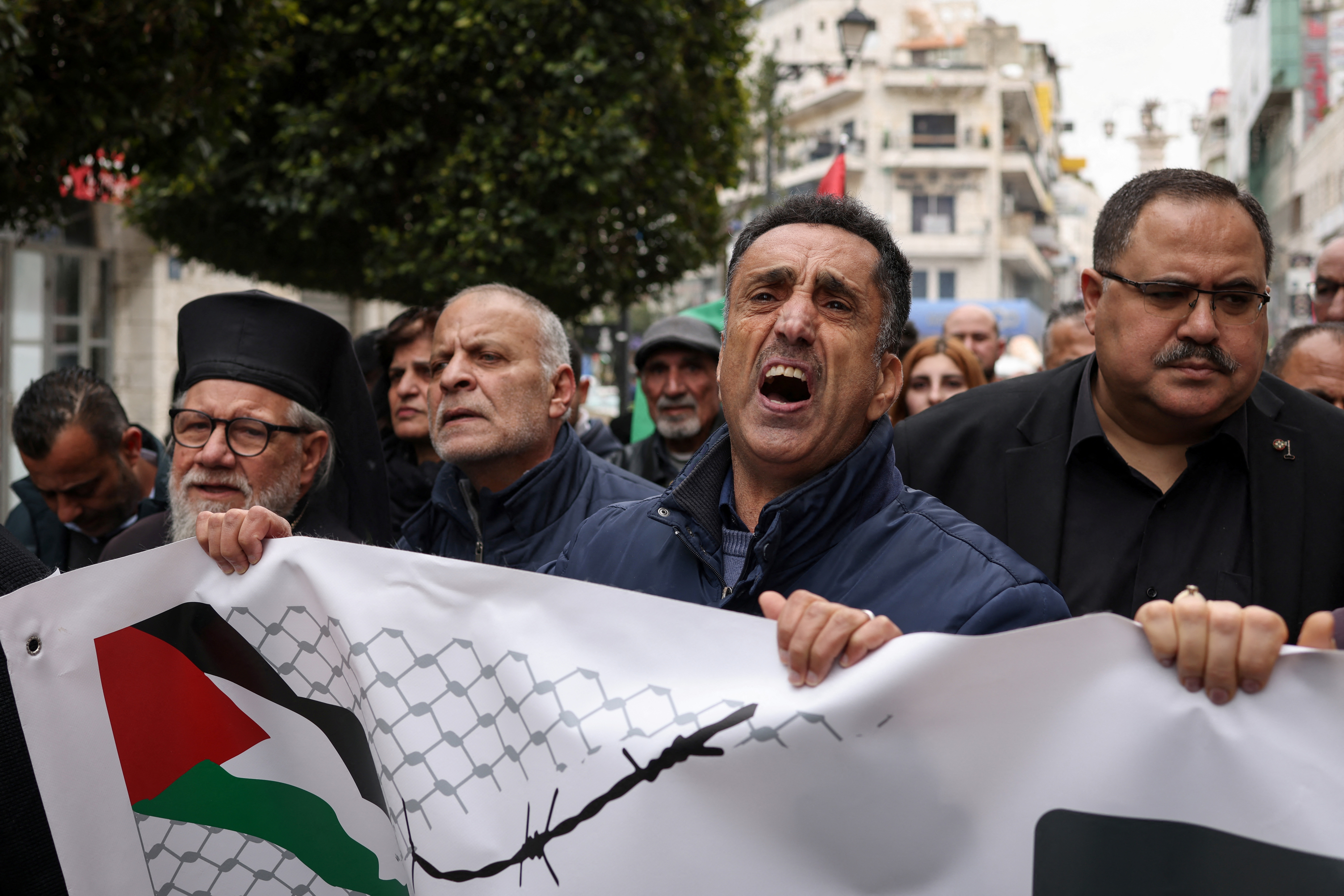 Palestinian demonstrators march in Ramallah in the occupied West Bank on April 1, 2026 during a protest against the Israeli parliament's approval of a new death penalty bill for Palestinians convicted of deadly attacks.