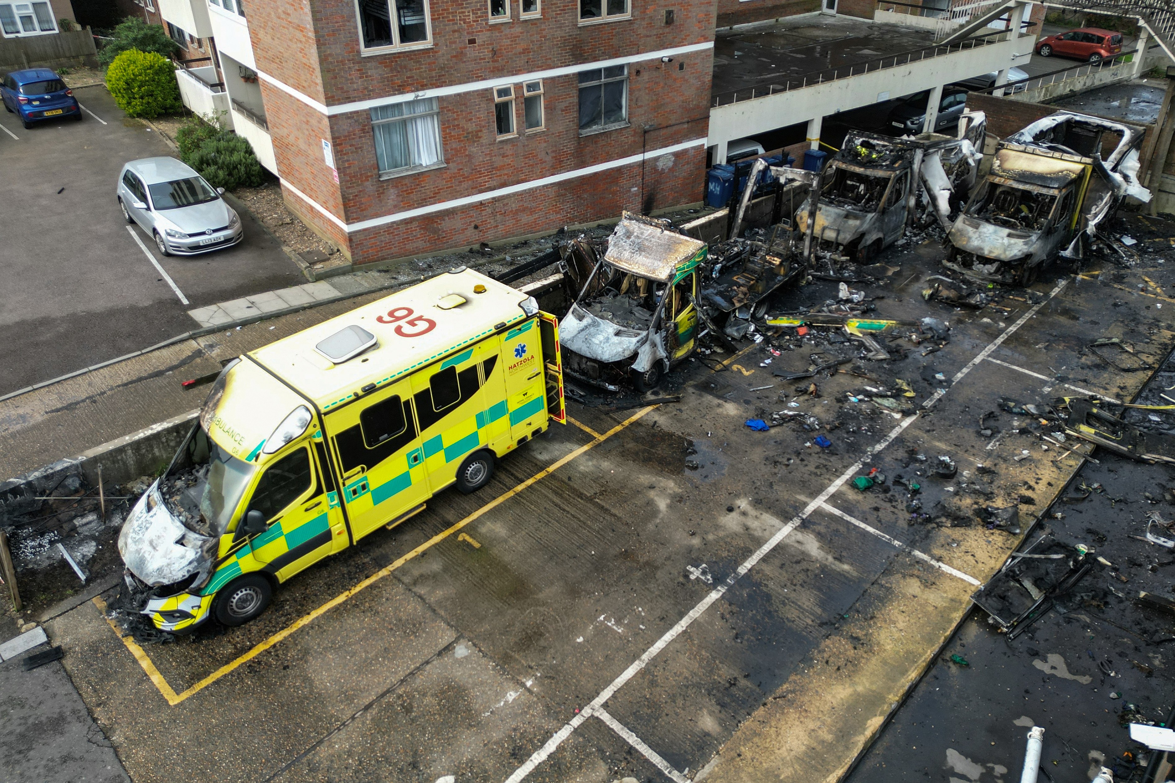 (FILES) This aerial image shows burnt out ambulances in a parking area along a street in the Golders Green neighbourhood of north London on March 23, 2026, after the volunteer ambulances run by a Jewish organisation were set on fire overnight.