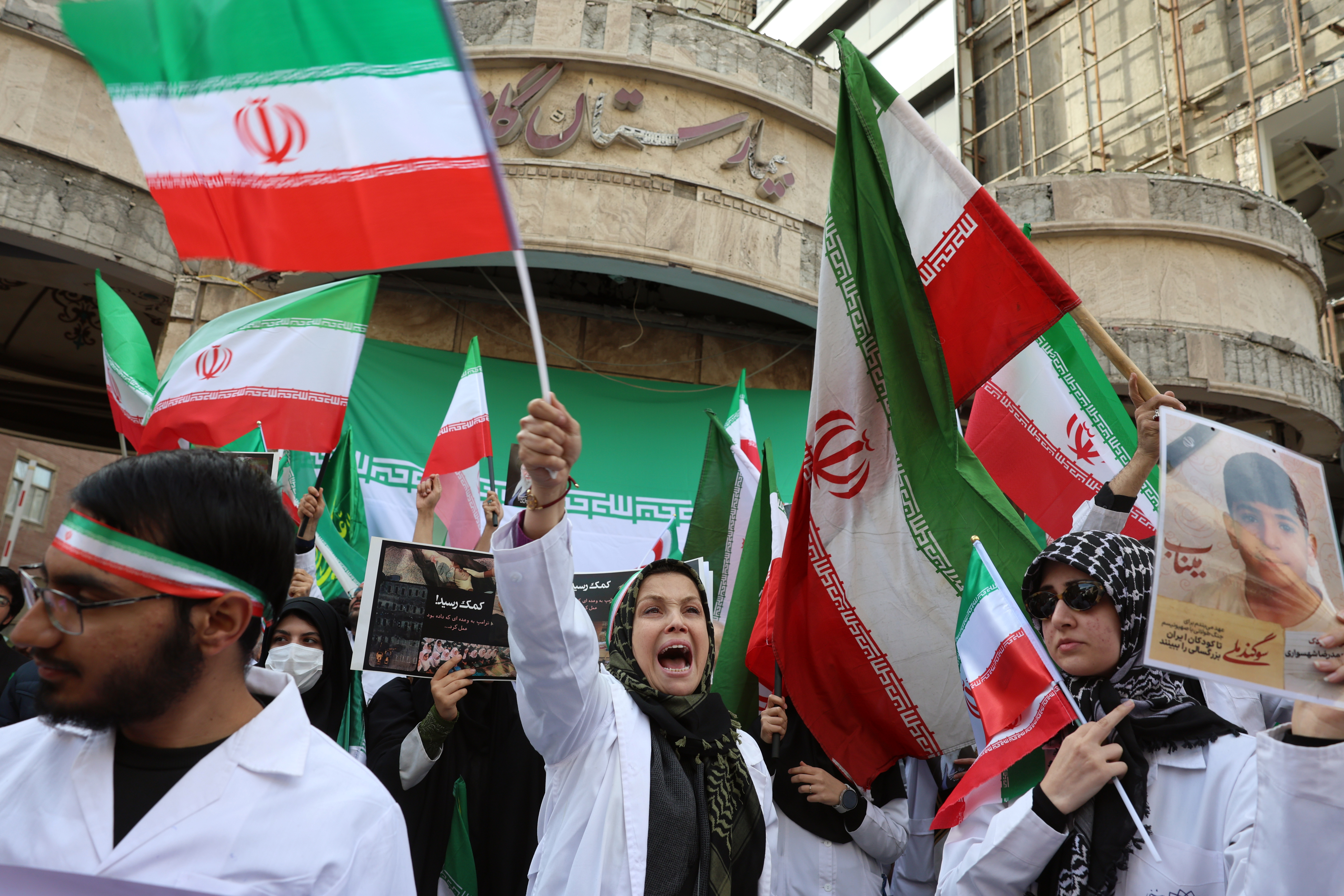 epa12801143 Members of Iranian medical personnel take part in a protest in front of the destroyed Gandhi Hospital by a US-Israel airstrike in Tehran, Iran, 07 March 2026. A joint US-Israeli military operation continued to target multiple locations across Iran, marking the eighth day of the conflict that began on 28 February. EPA/ABEDIN TAHERKENAREH