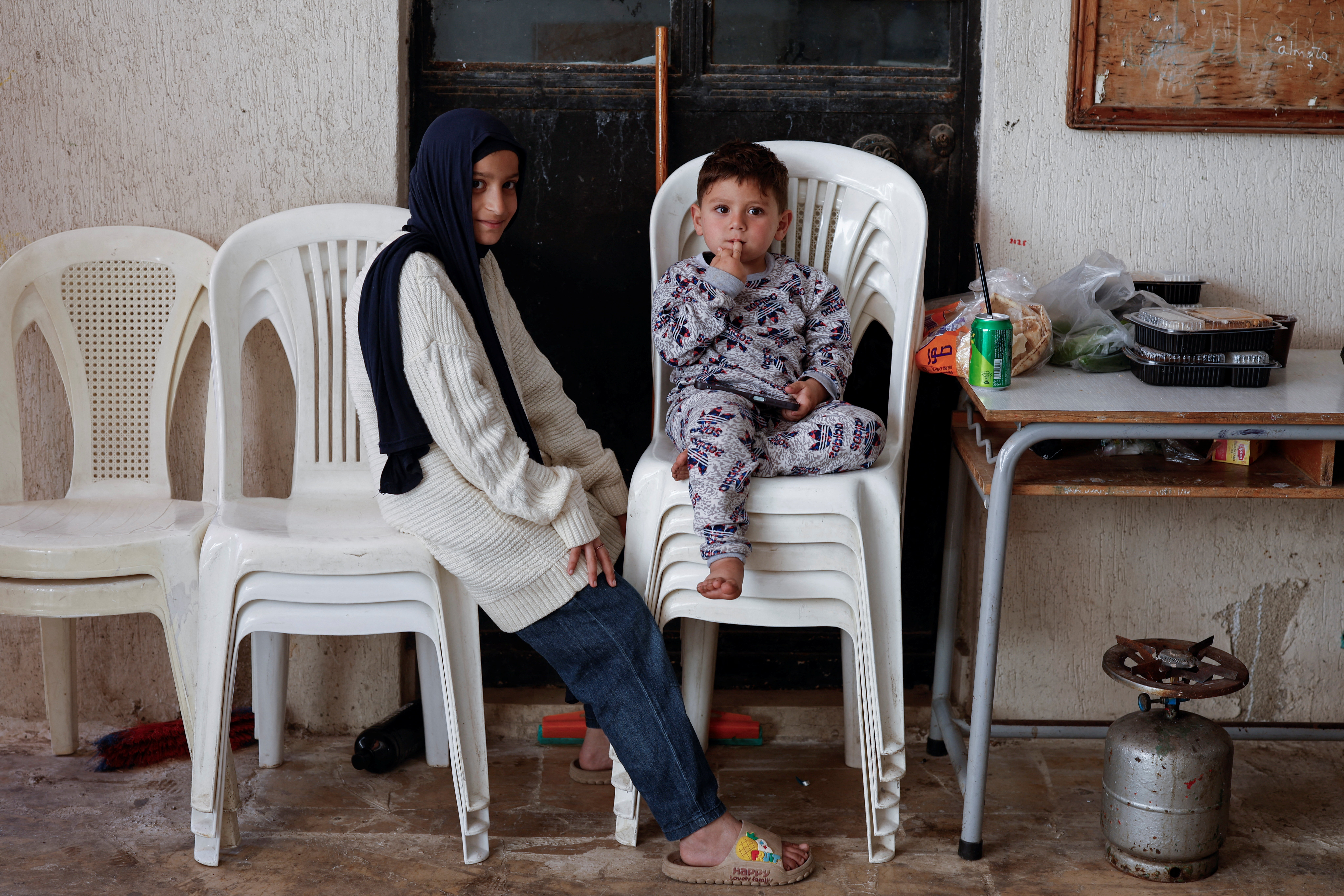 Children sit at a yard of an all-girls high school, turned into a shelter for displaced people, in Tyre, Lebanon, April 12, 2026. REUTERS/Louisa Gouliamaki TPX IMAGES OF THE DAY