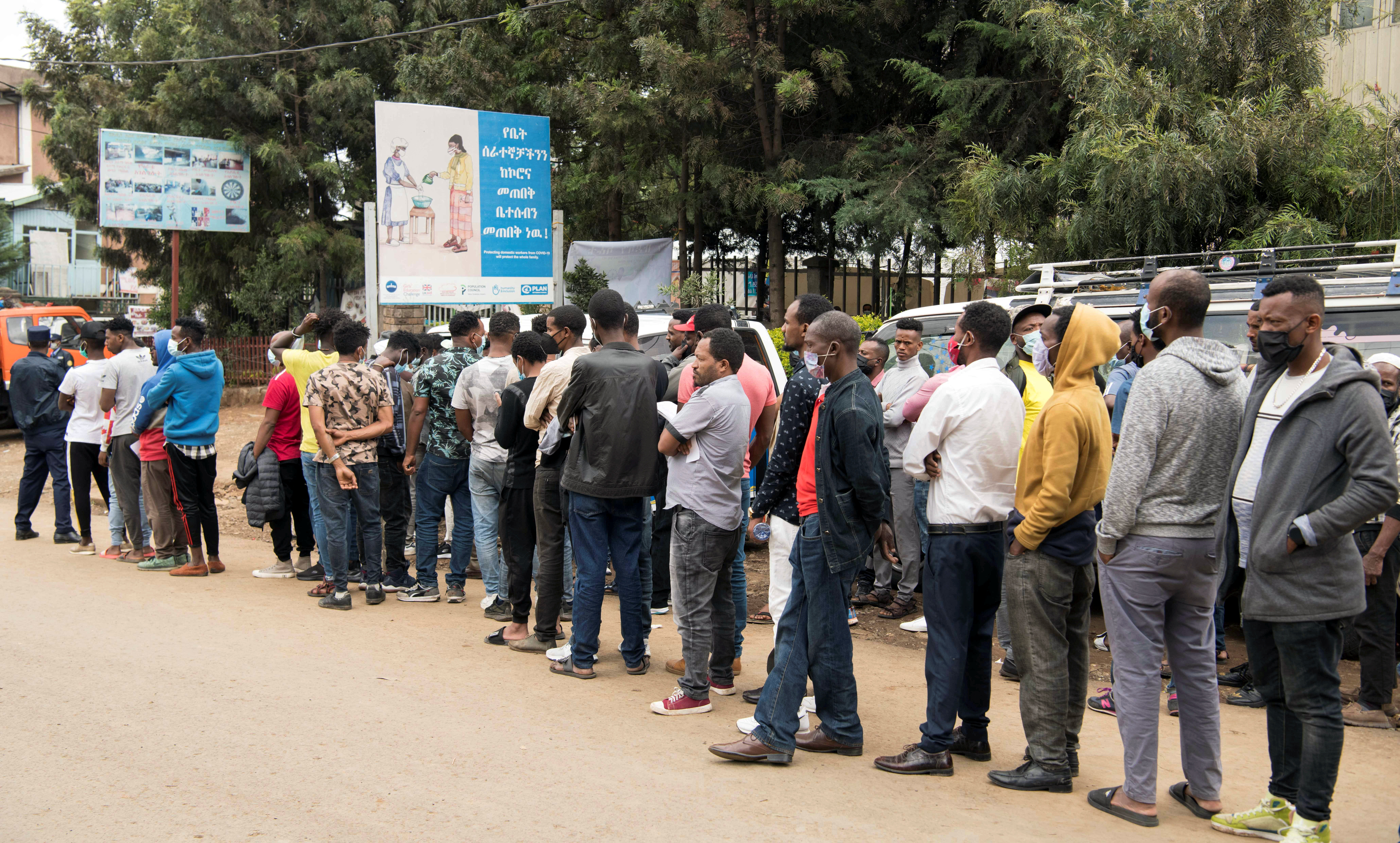 People queue outside a polling station during the Ethiopian parliamentary and regional elections, near Addisu Michael, in Addis Ababa, Ethiopia June 21, 2021. REUTERS/Maheder Haileselassie Tadese