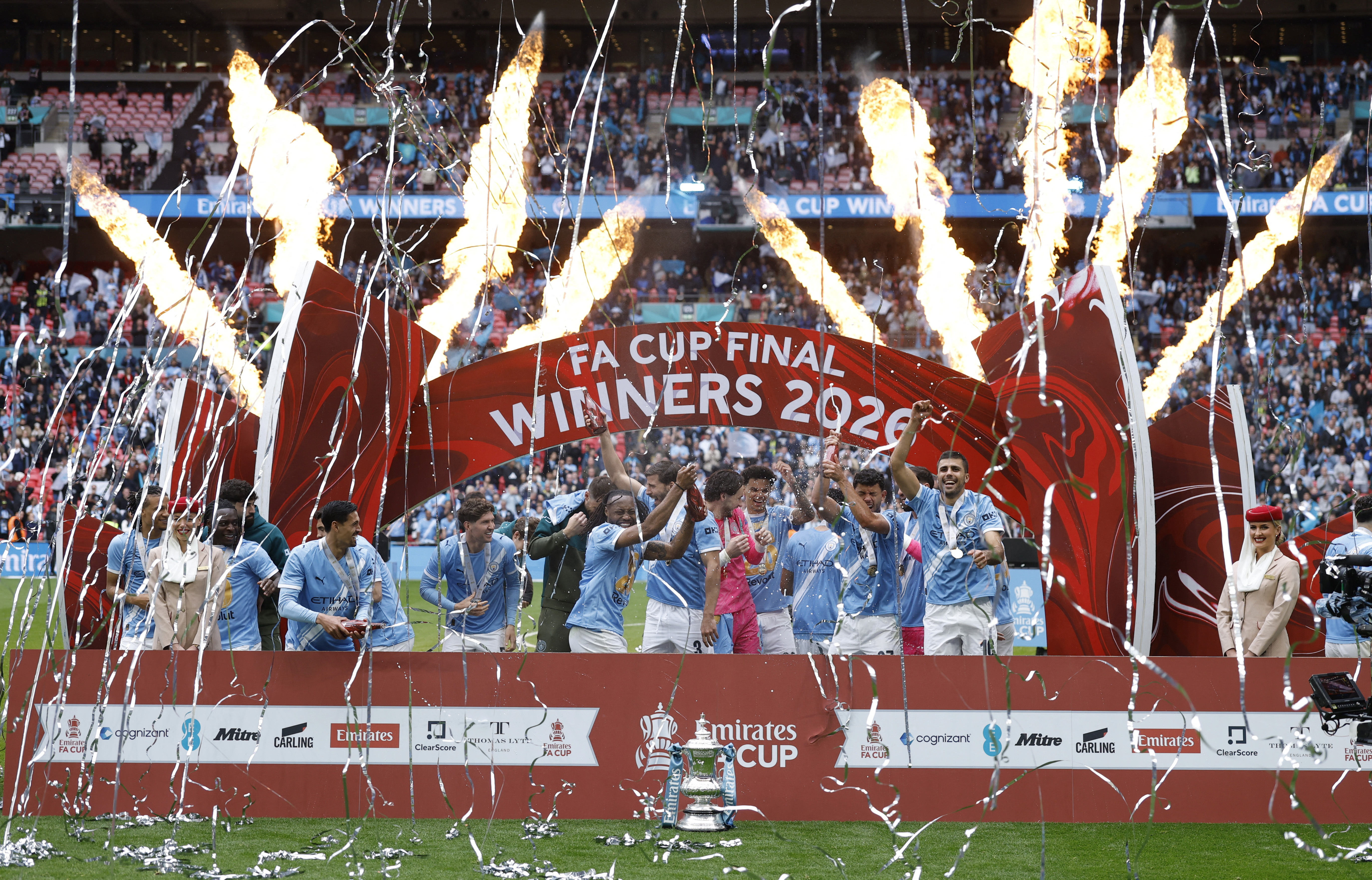 Manchester City players celebrate with the FA Cup trophy