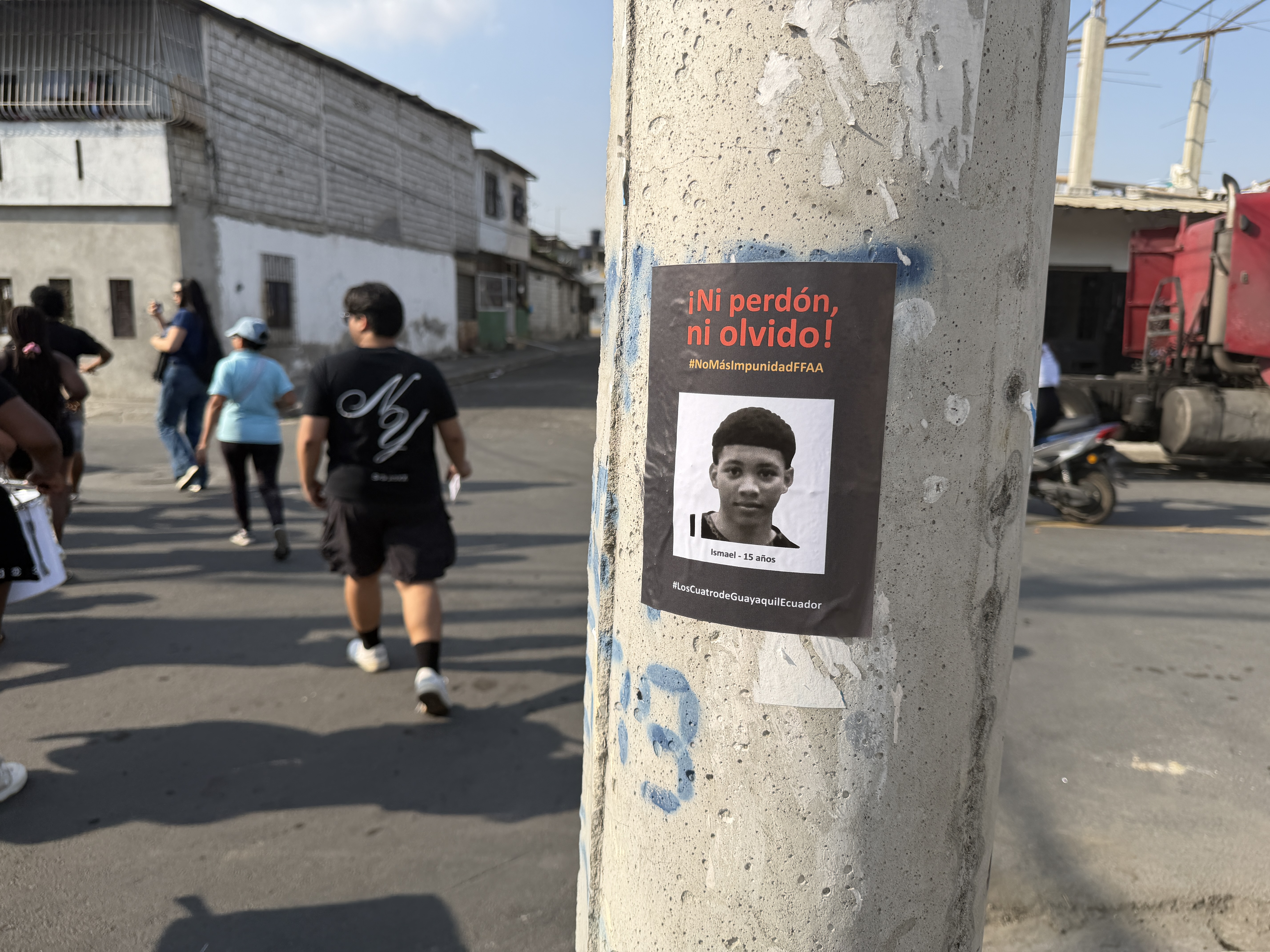 A poster on a street pole shows a teenage boy abducted by Ecuadorian soldiers and later found dead