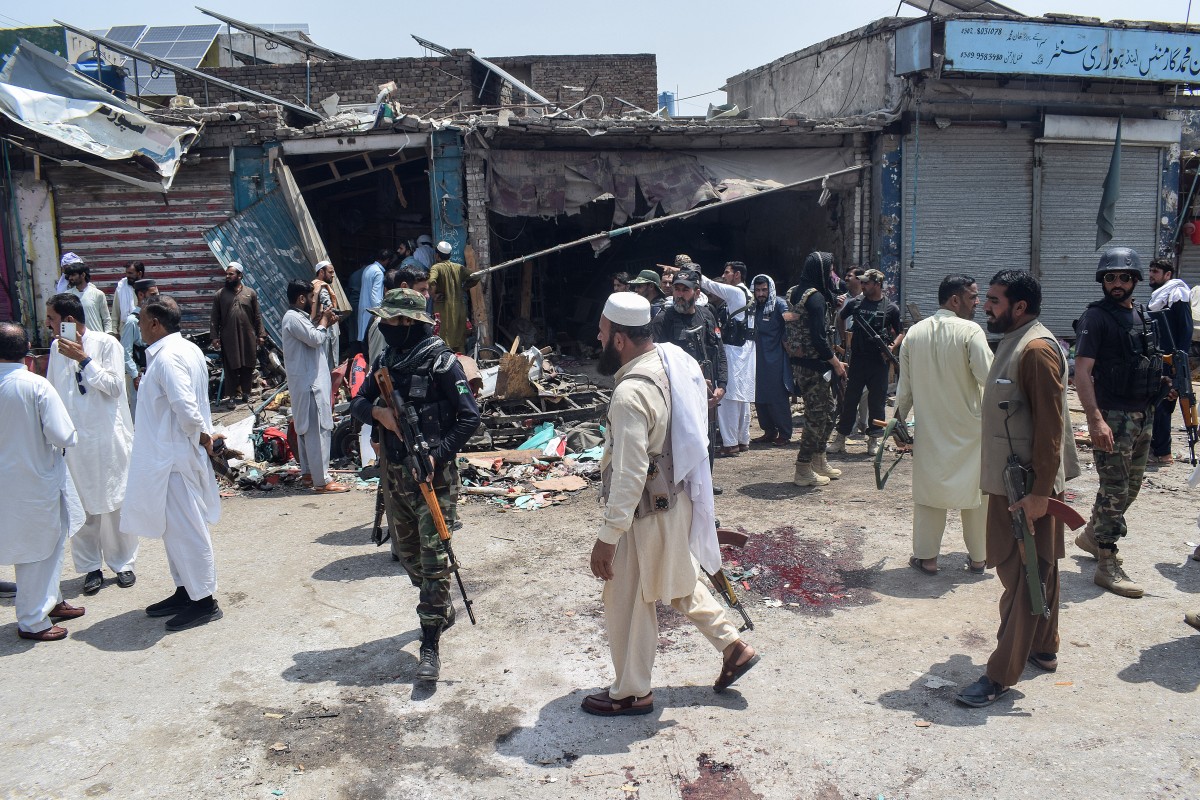 Security personnel inspect the blast site after a suicide attack in the Sarai Naurang area of Pakistans Lakki Marwat district on May 12, 2026. A suicide bomber in a three-wheel vehicle laden with explosives killed at least seven people and wounded 20 in northwest Pakistan, police said on May 12. (Photo by Marwat AKBAR / AFP)