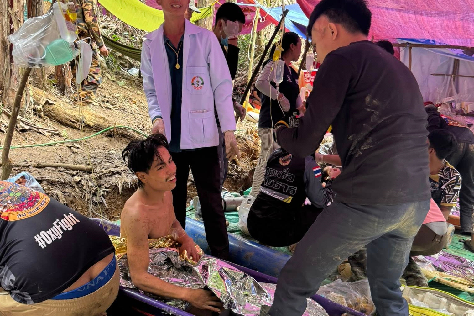 Rescuers gather after evacuating villagers trapped for more than a week in a flooded cave in Xaisomboun province, Laos. [Association of Volunteers for Lao People via AP]