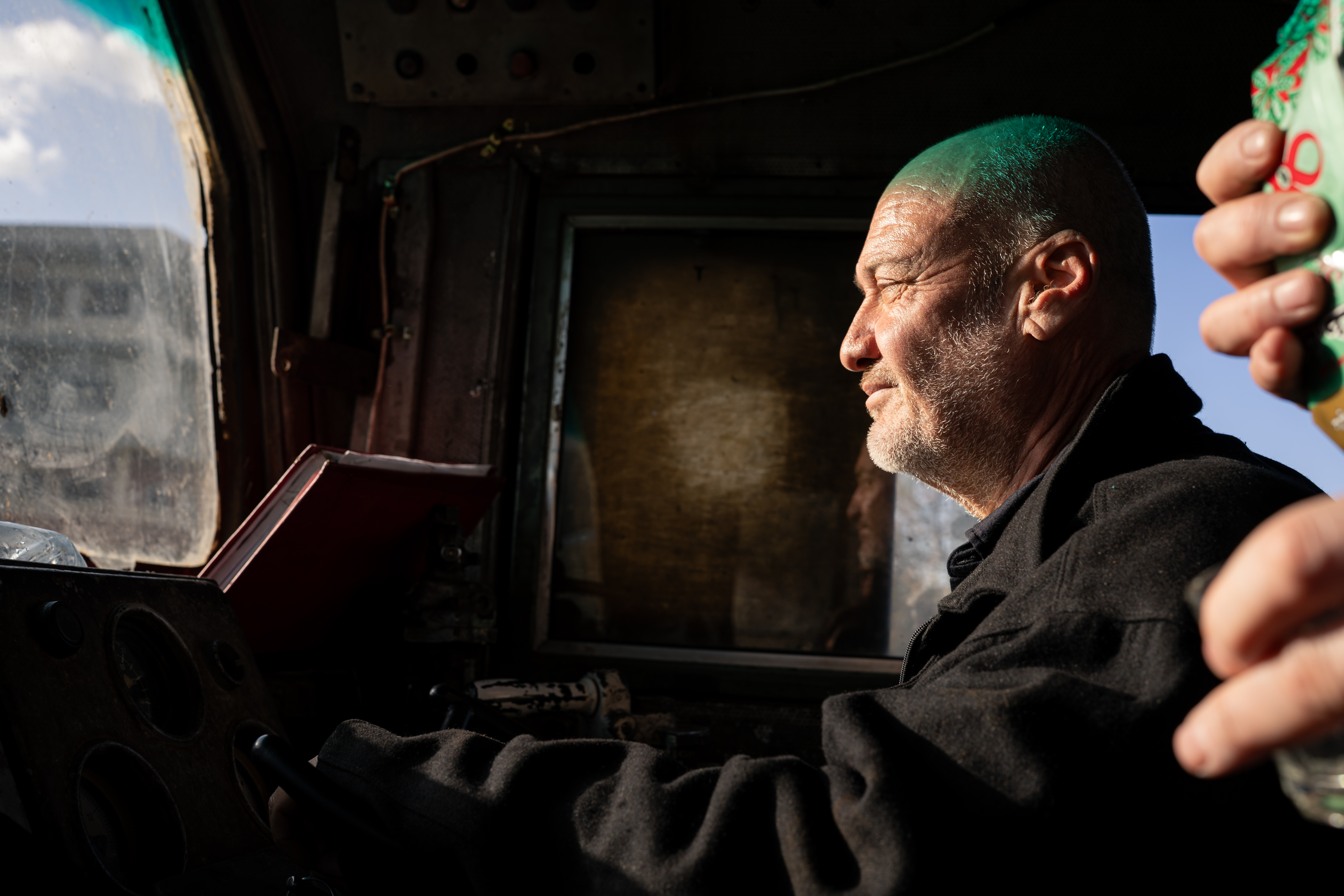 Mohammad, the assistant to train driver Abu Mahmoud, waits for departure from Tartous Station in Baniyas [Charles Cuau/Al Jazeera]