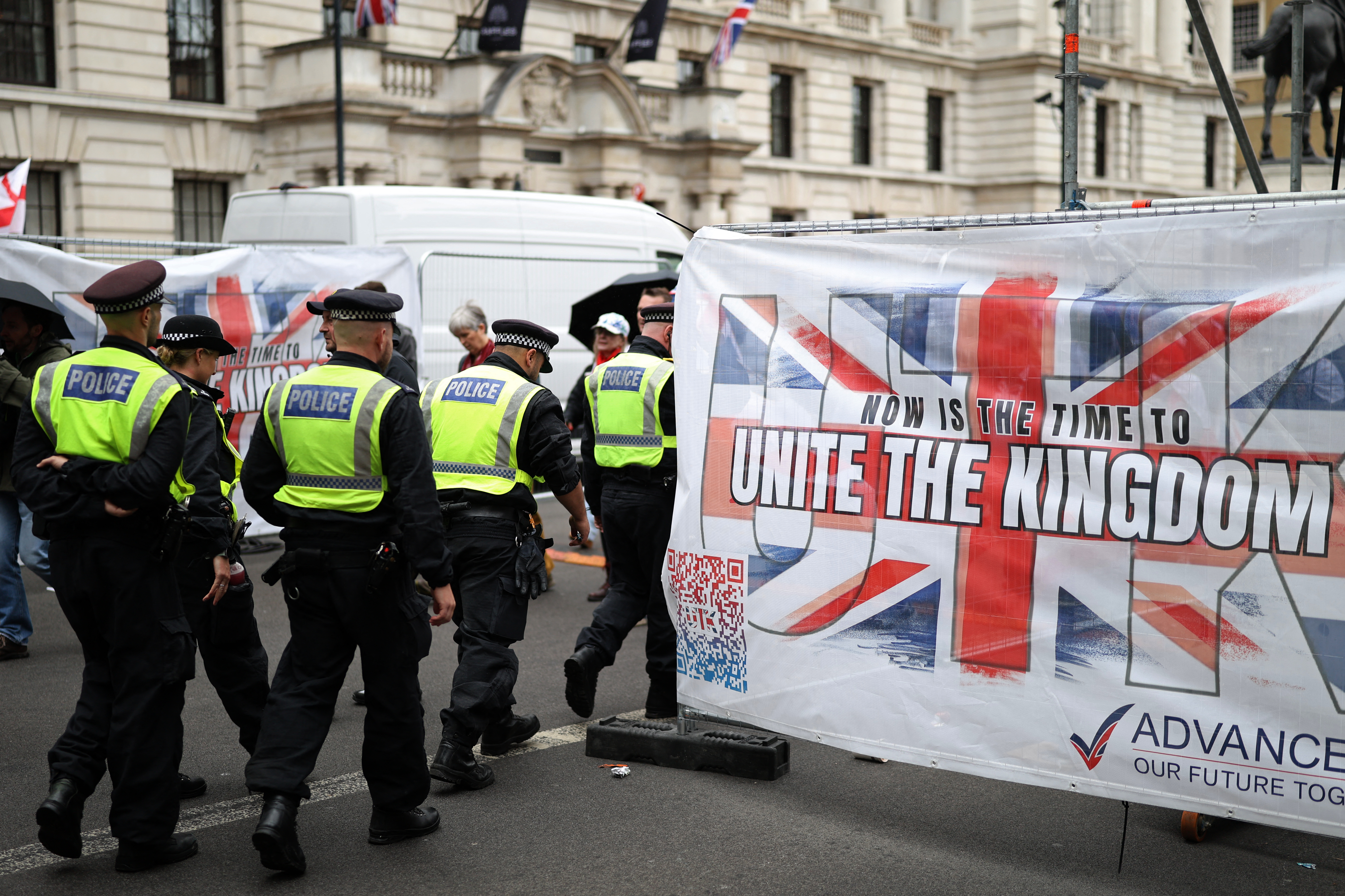 Police officers begin to move off after a march organised by Unite The Kingdom, in central London, on May 16, 2026 [AFP]