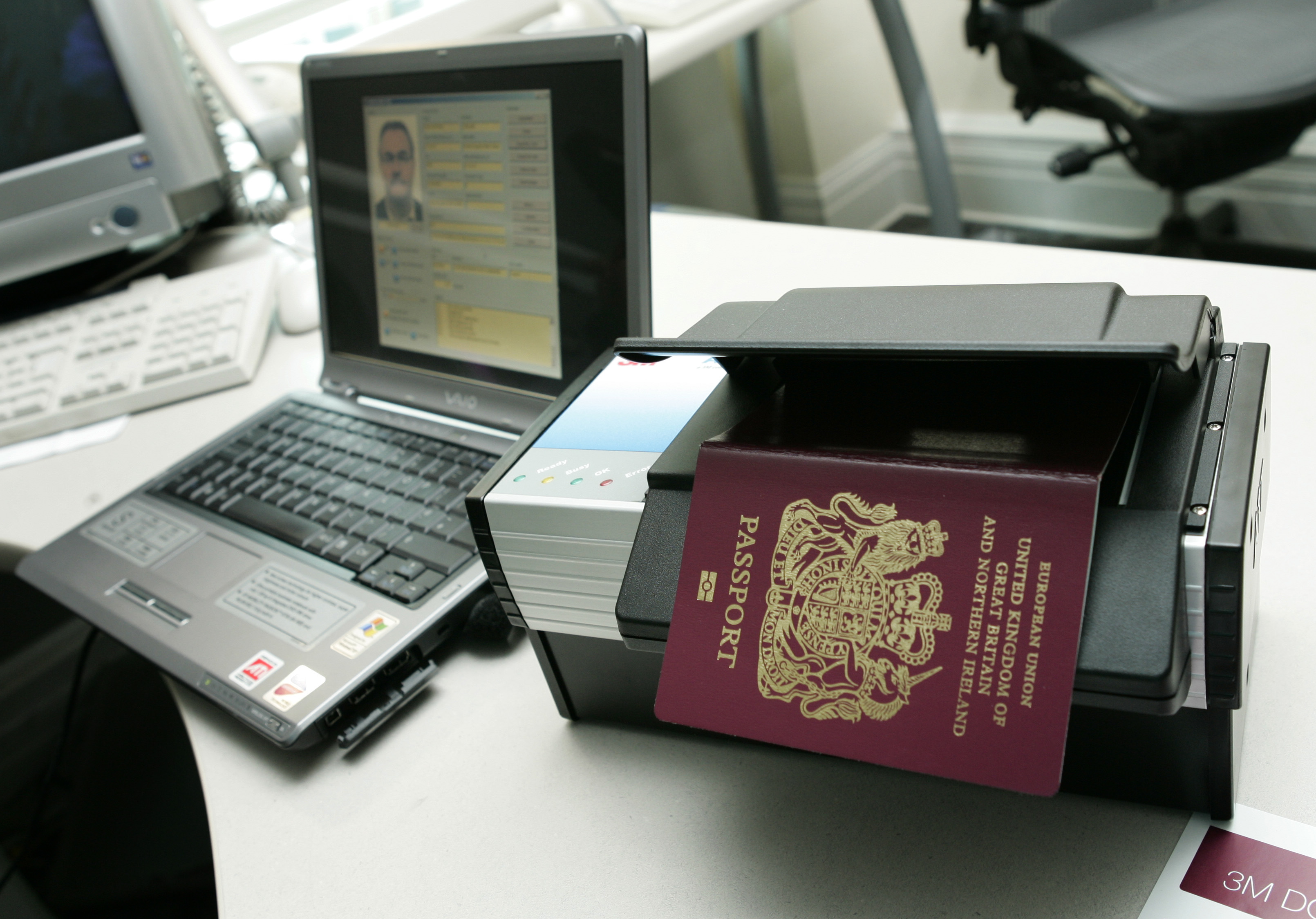 A new British biometric passport is shown atop a special reader can take the holder's information off an embedded security chip, during a showing for the press at the British Embassy in Washington, October 24, 2005. Under the first phase of a week-long test of the UK's new biometric passport issuing system, the new biometric passports are embedded with features like a security chip bearing the passport holder's personal information along with other security features to help prevent passport forgery. All 27 nations that currently hold special visa-free status with the U.S. are required to begin issuing biometric passports by October 26, 2006 in order to meet U.S. government passport control deadlines. [Jason Reed/Reuters]