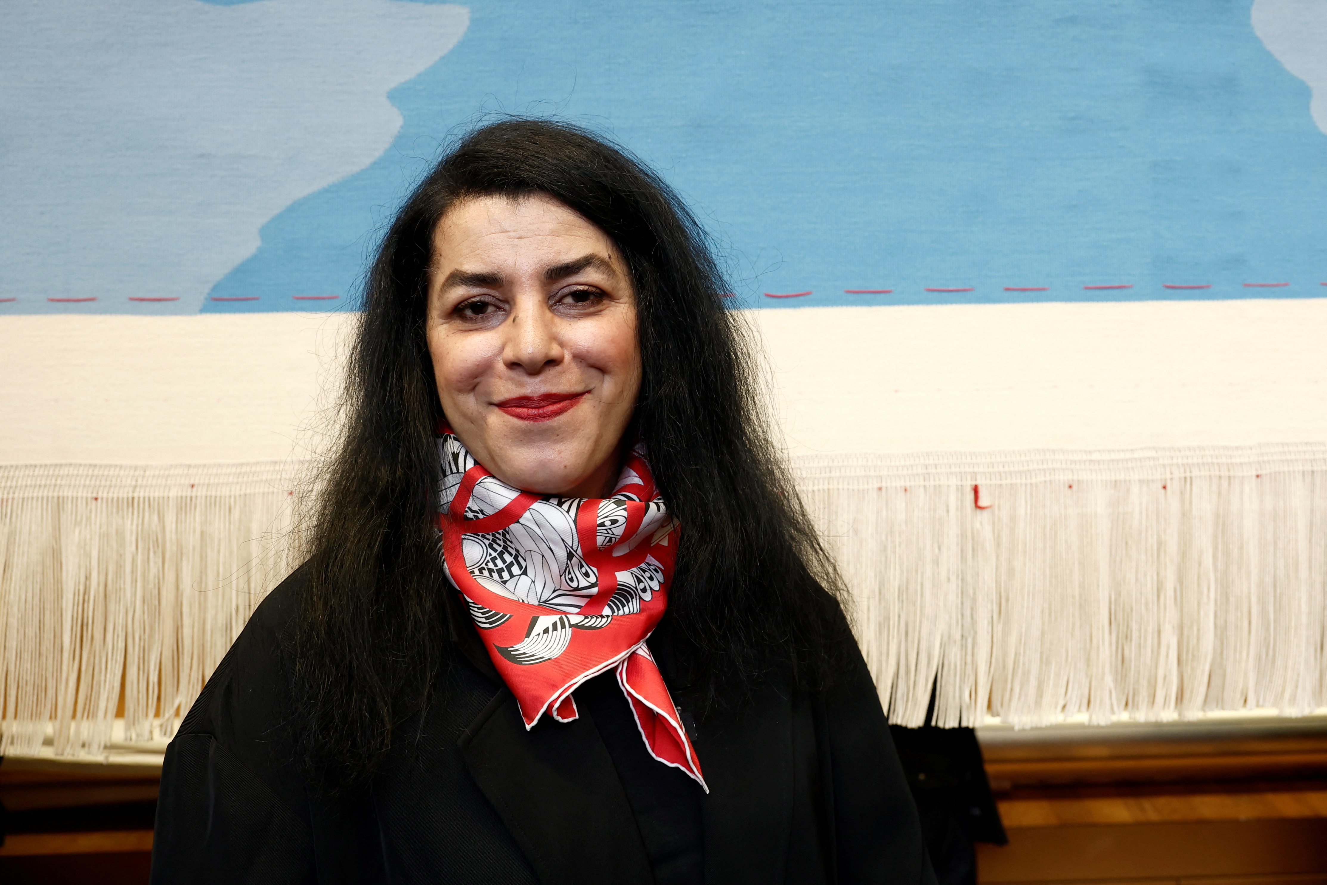 French-Iranian artist Marjane Satrapi poses in front of the Olympic tapestry in Paris,