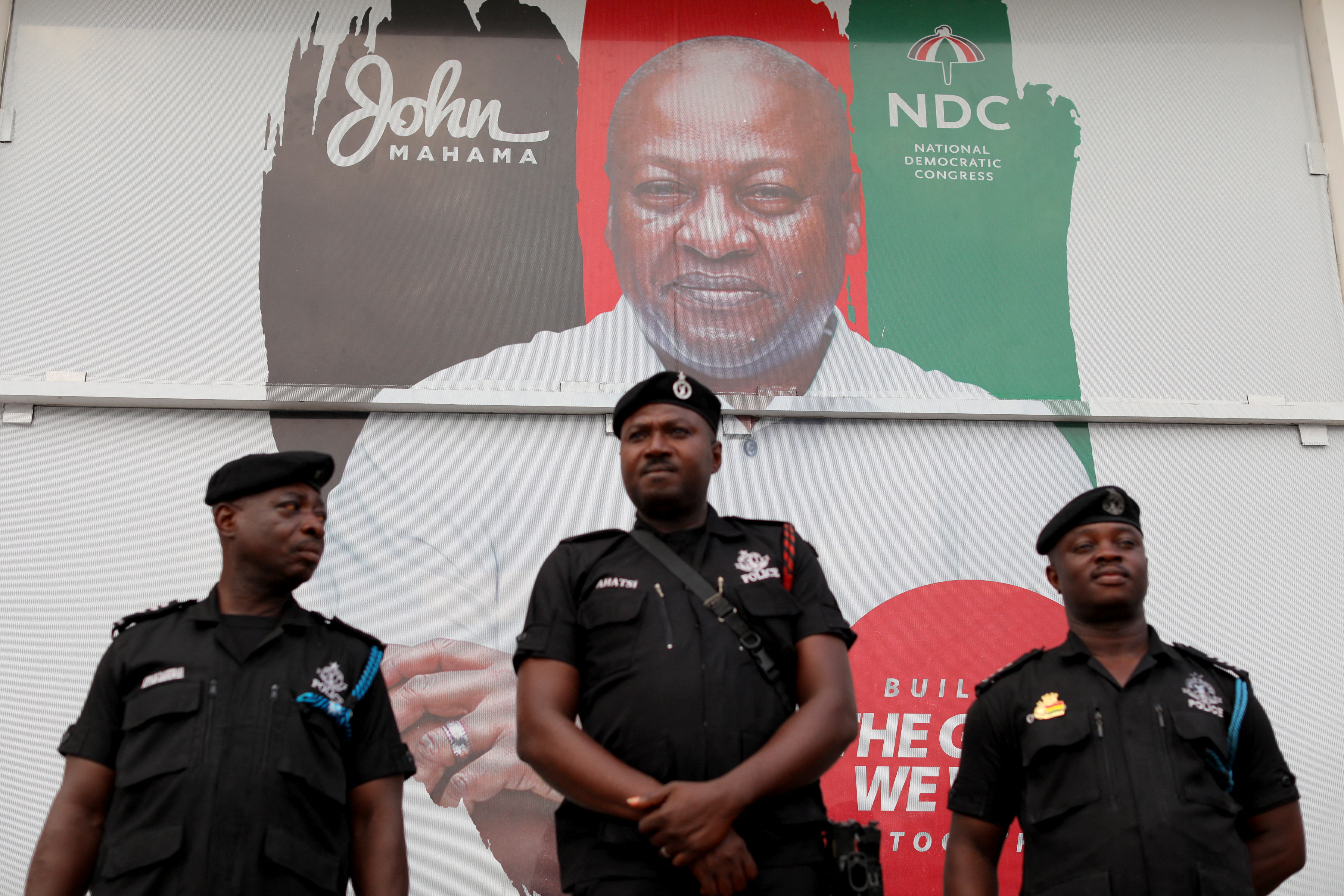 A large campaign image of then-presidential candidate John Mahama surrounded by police officers during the election that brought him to office. [Francis Kokoroko/Reuters]