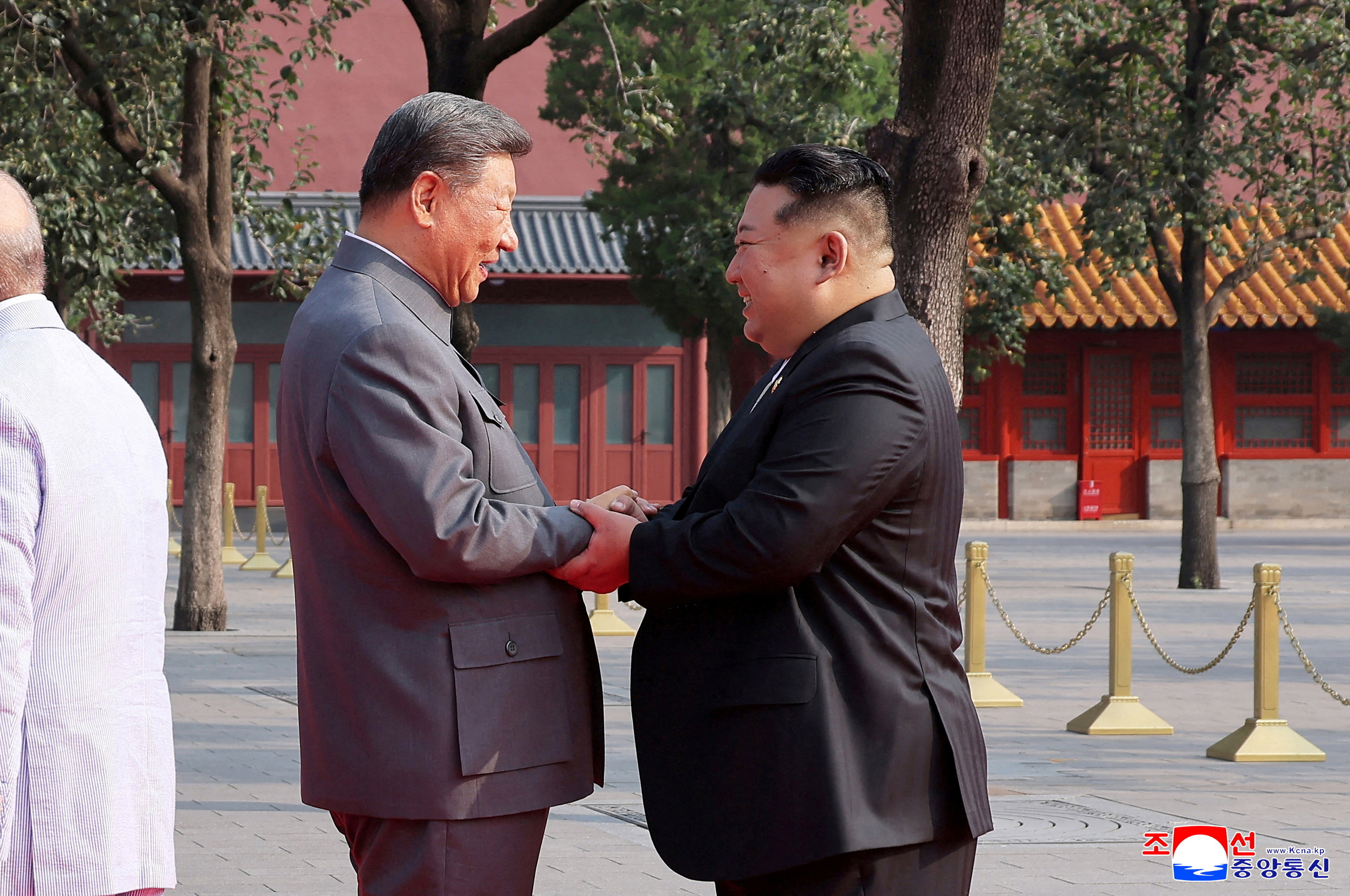 North Korean leader Kim Jong Un shakes hands with Chinese President Xi Jinping.