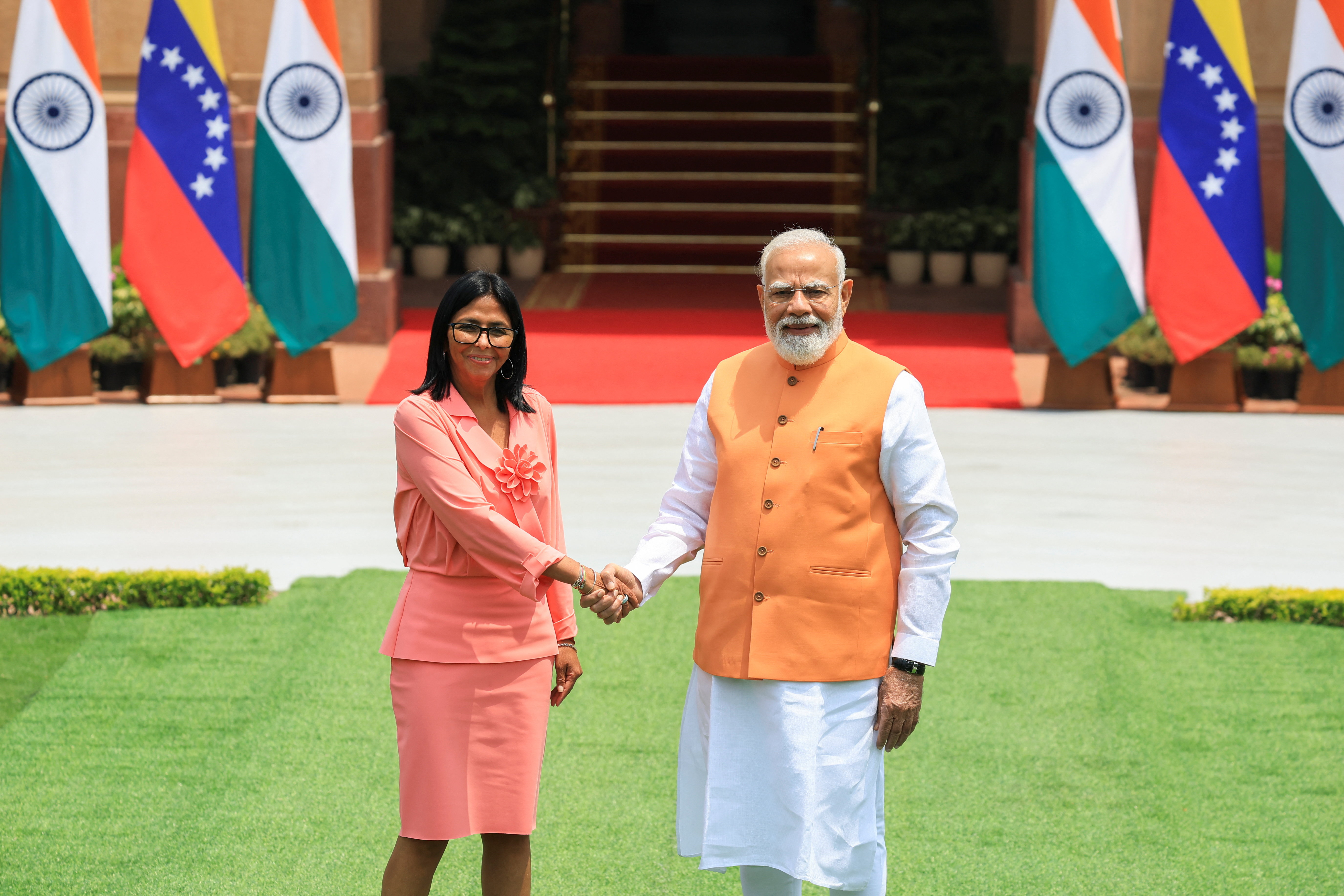 Venezuela's interim President Delcy Rodriguez shakes hands with India's Prime Minister Narendra Modi