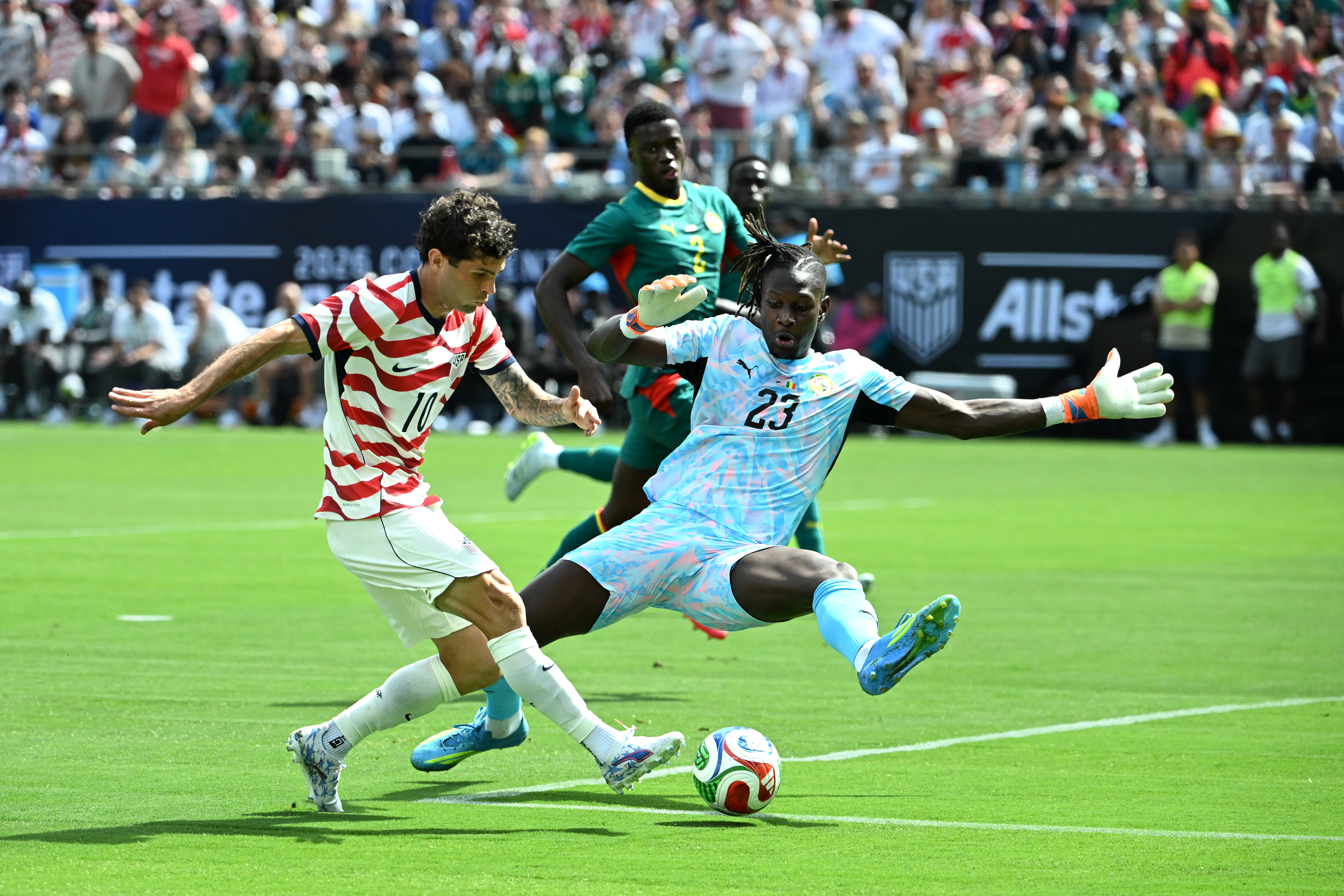 May 31, 2026; Charlotte, North Carolina, USA; United States Christian Pulisic (10) scores as Senegal goalkeeper Mory Diaw (23) defends in the first half at Bank of America Stadium. Mandatory Credit: Bob Donnan-Imagn Images