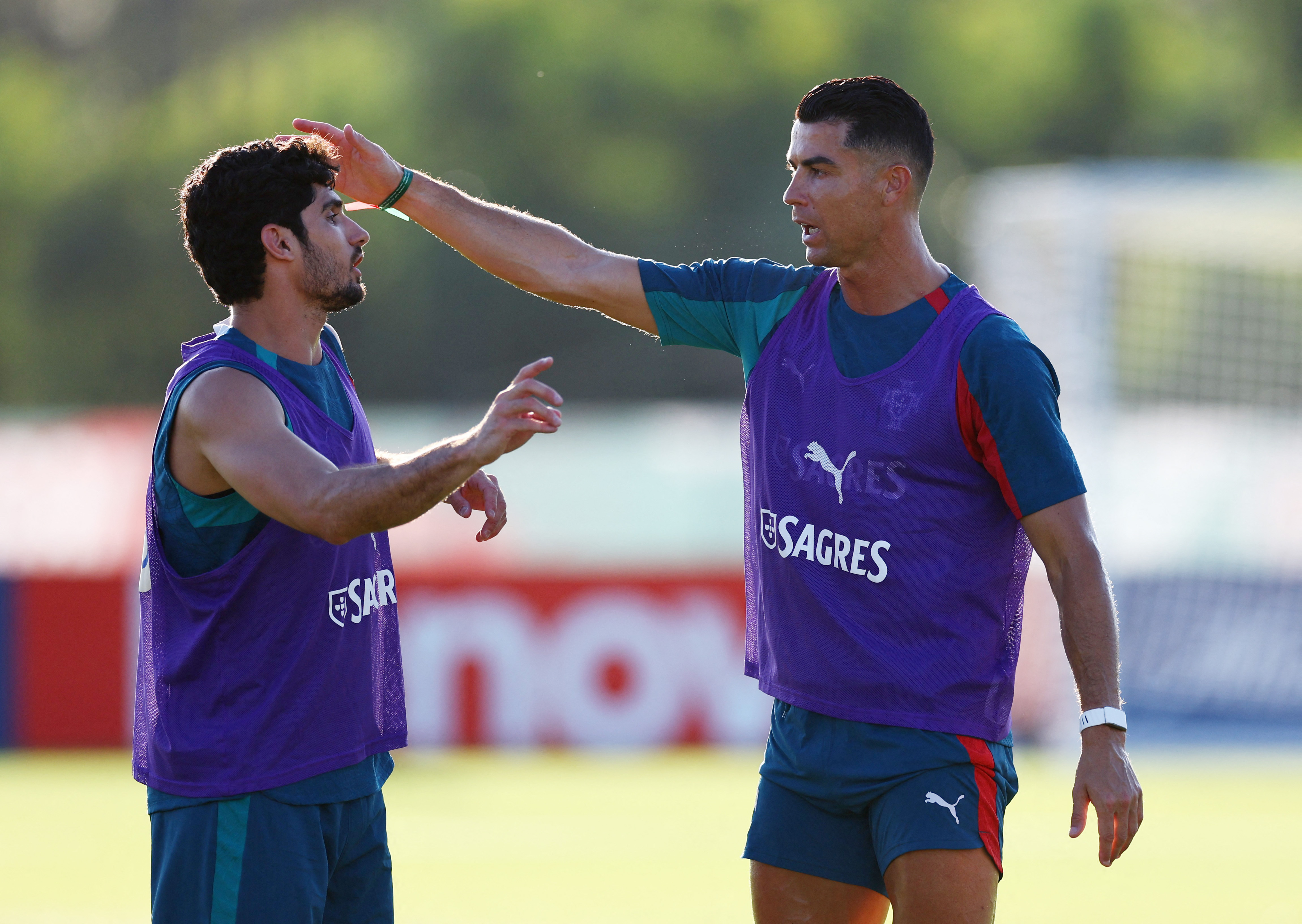 Portugal’s Cristiano Ronaldo makes his point to Goncalo Guedes during training