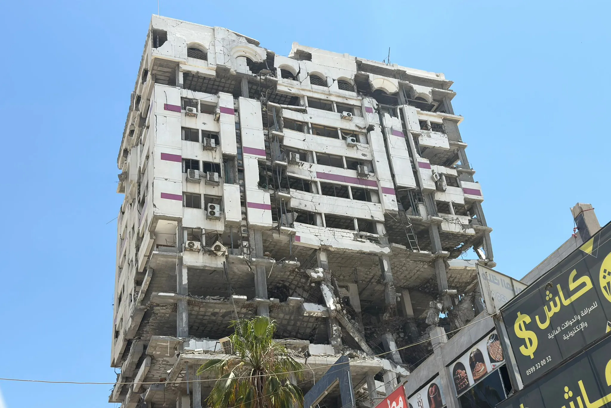 Palestine Tower, once a prominent hub for major tech, entrepreneurship, and freelance companies in the Gaza Strip, stands in ruins after being destroyed during the Israeli war [Eyad Al-Qatrawi].