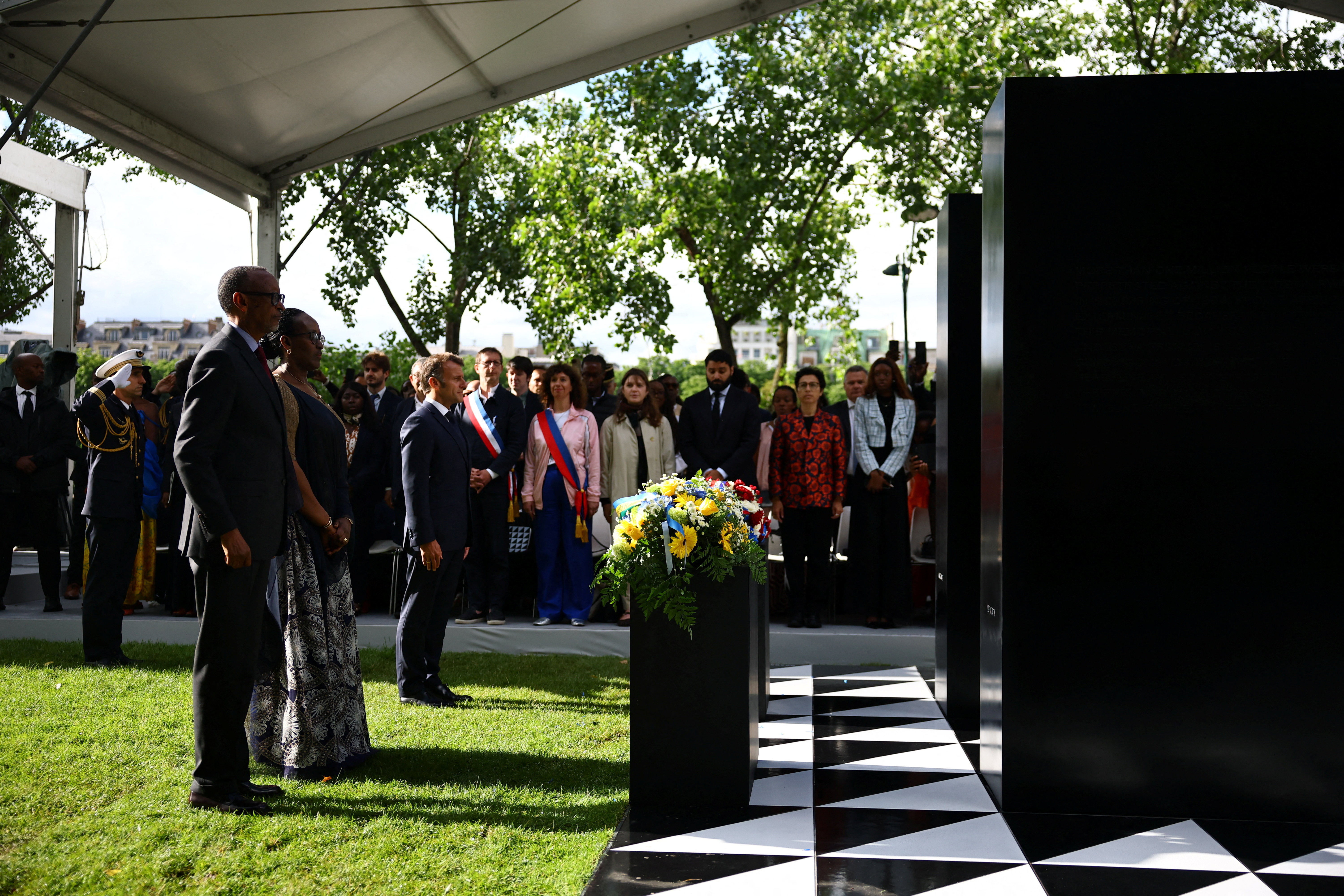 (From L) Rwanda's President Paul Kagame, Rwanda's First Lady Jeannette Kagame and France's President Emmanuel Macron stand after laying wreaths of flowers on a monument for honouring the victims of the Rwanda's genocide made by the Portuguese artist Grada Kilomba, during a ceremony on the Habib-Bourguiba Esplanade along the Seine River in Paris, on June 2, 2026. (Photo by Sarah Meyssonnier / POOL / AFP) / RESTRICTED TO EDITORIAL USE - MANDATORY MENTION OF THE ARTIST UPON PUBLICATION - TO ILLUSTRATE THE EVENT AS SPECIFIED IN THE CAPTION