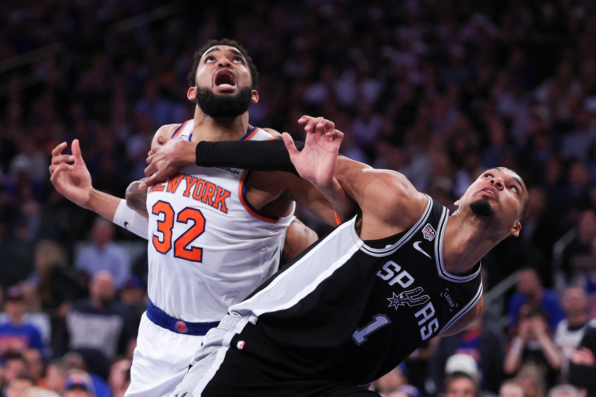 Victor Wembanyama #1 of the San Antonio Spurs and Karl-Anthony Towns #32 of the New York Knicks battle for position.